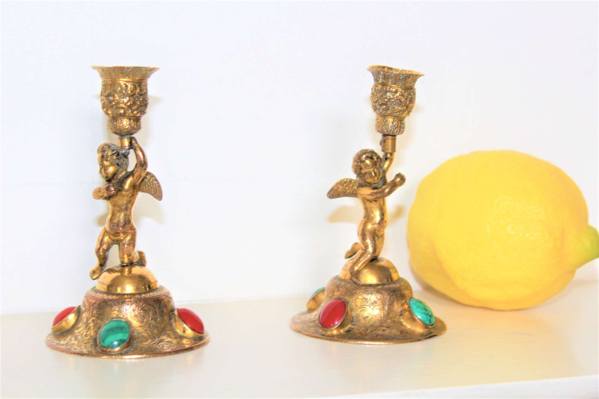 A Pair Of Small Ormolu Antique Candlesticks Depicting Winged Cherubs