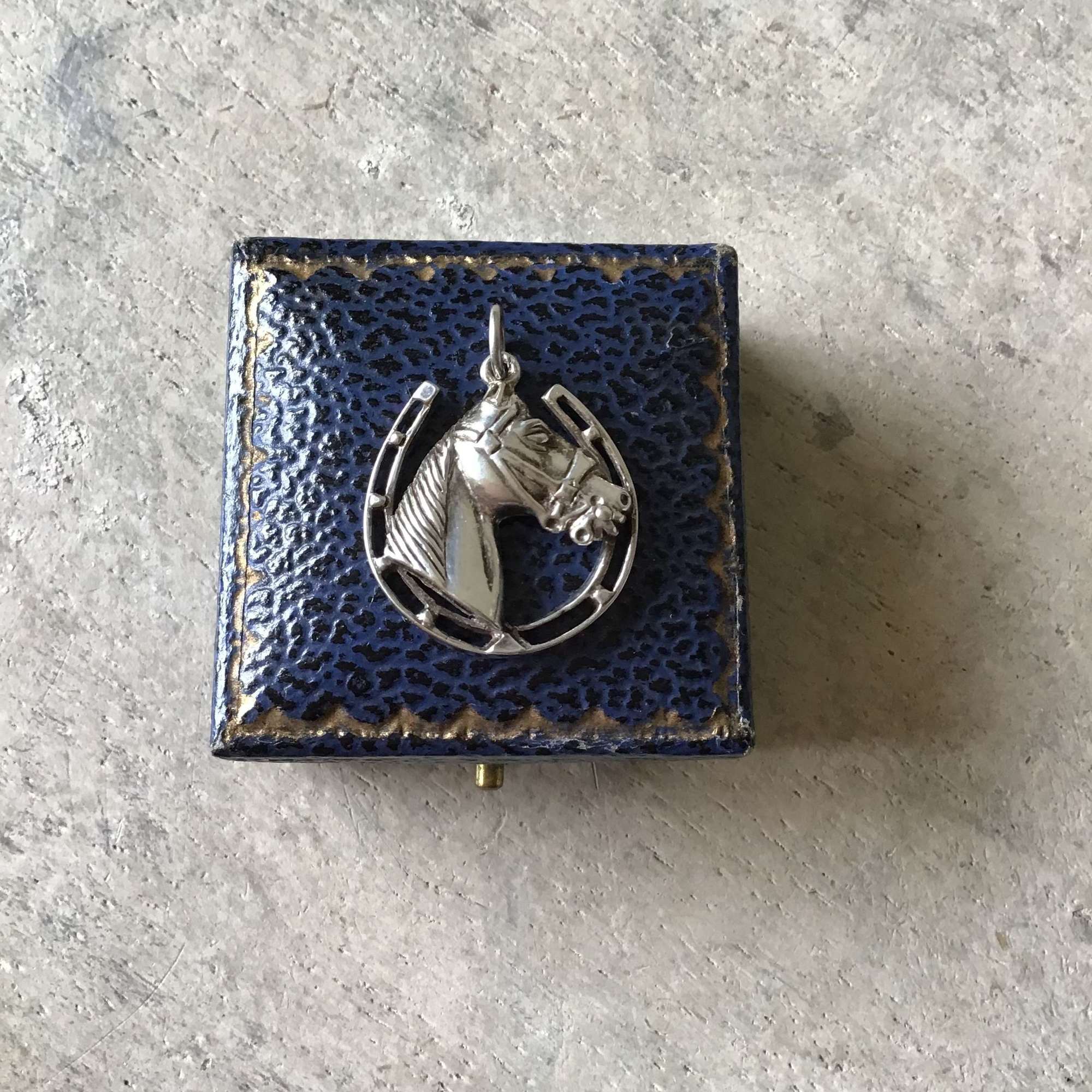 Vintage silver horse in a horseshoe pendant