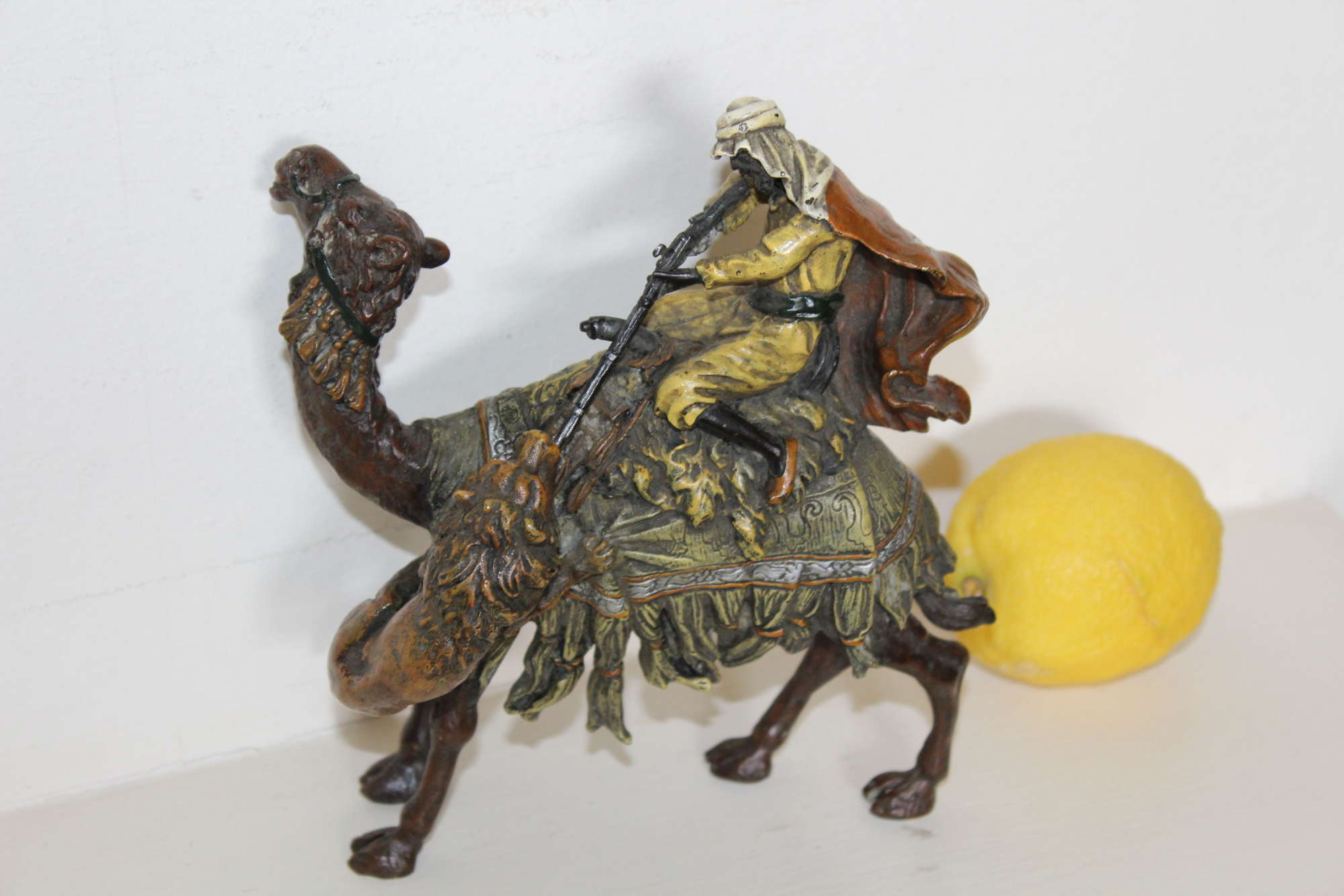 A Finely Cast Cold Painted Bronze Of An Arabic Man Riding A Camel