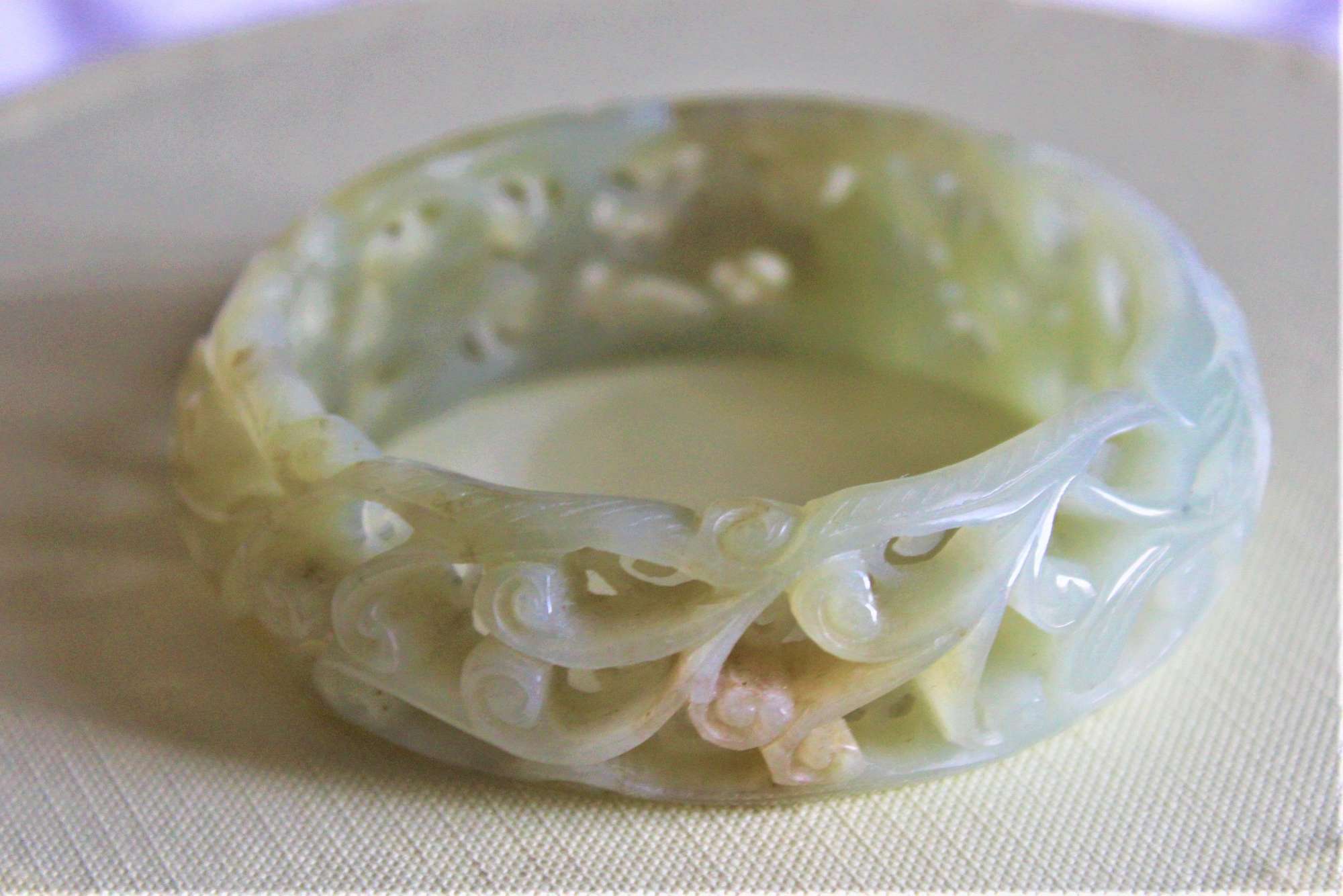 A Very Fine And Deeply Carved Celadon Jade Bangle