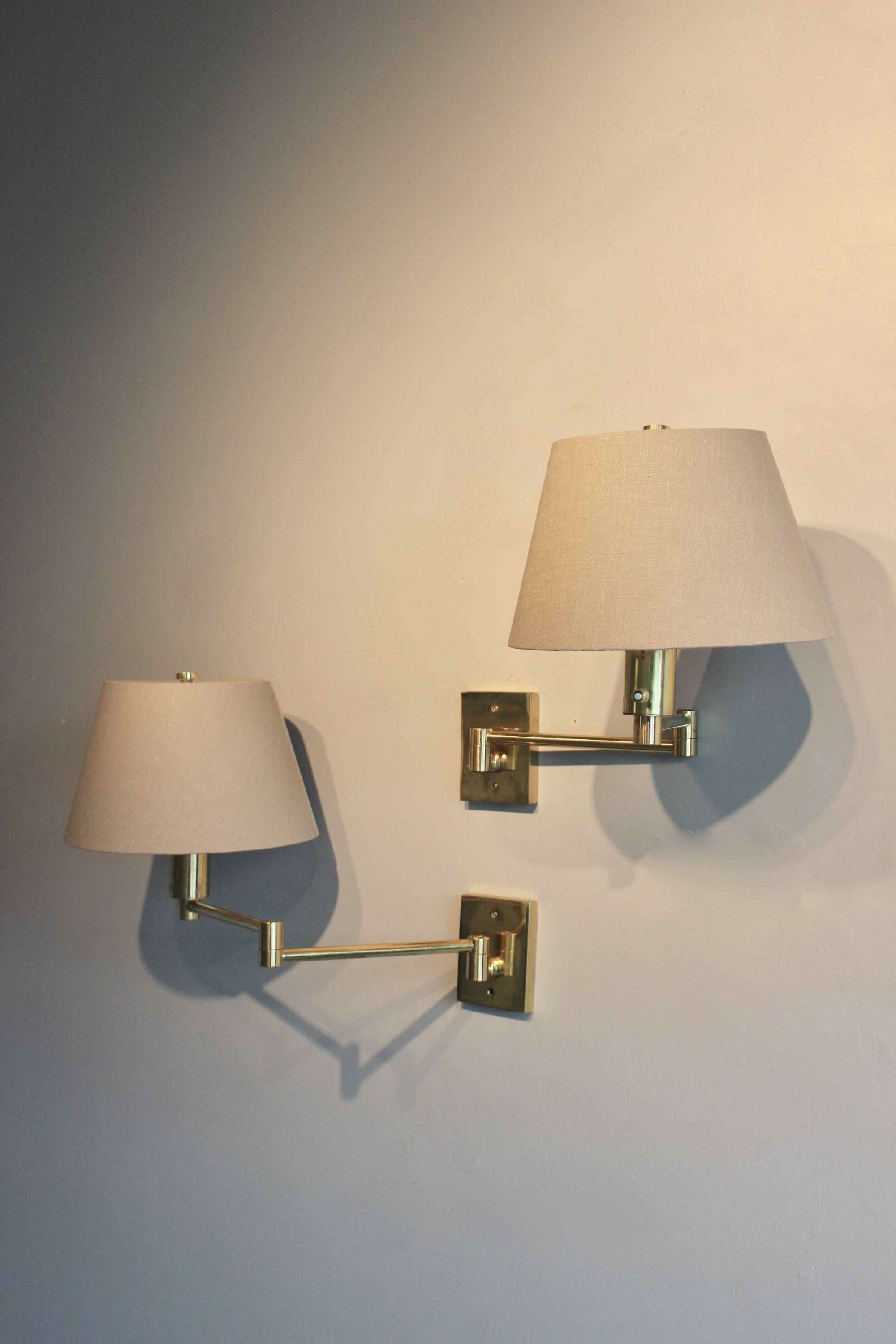 Pair of brass swing arm lights with custom shades