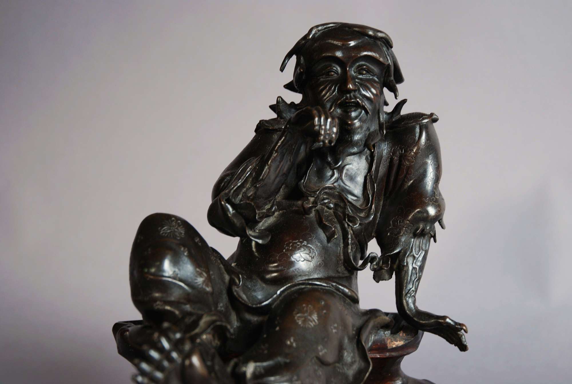 Chinese bronze of seated old man, signed
