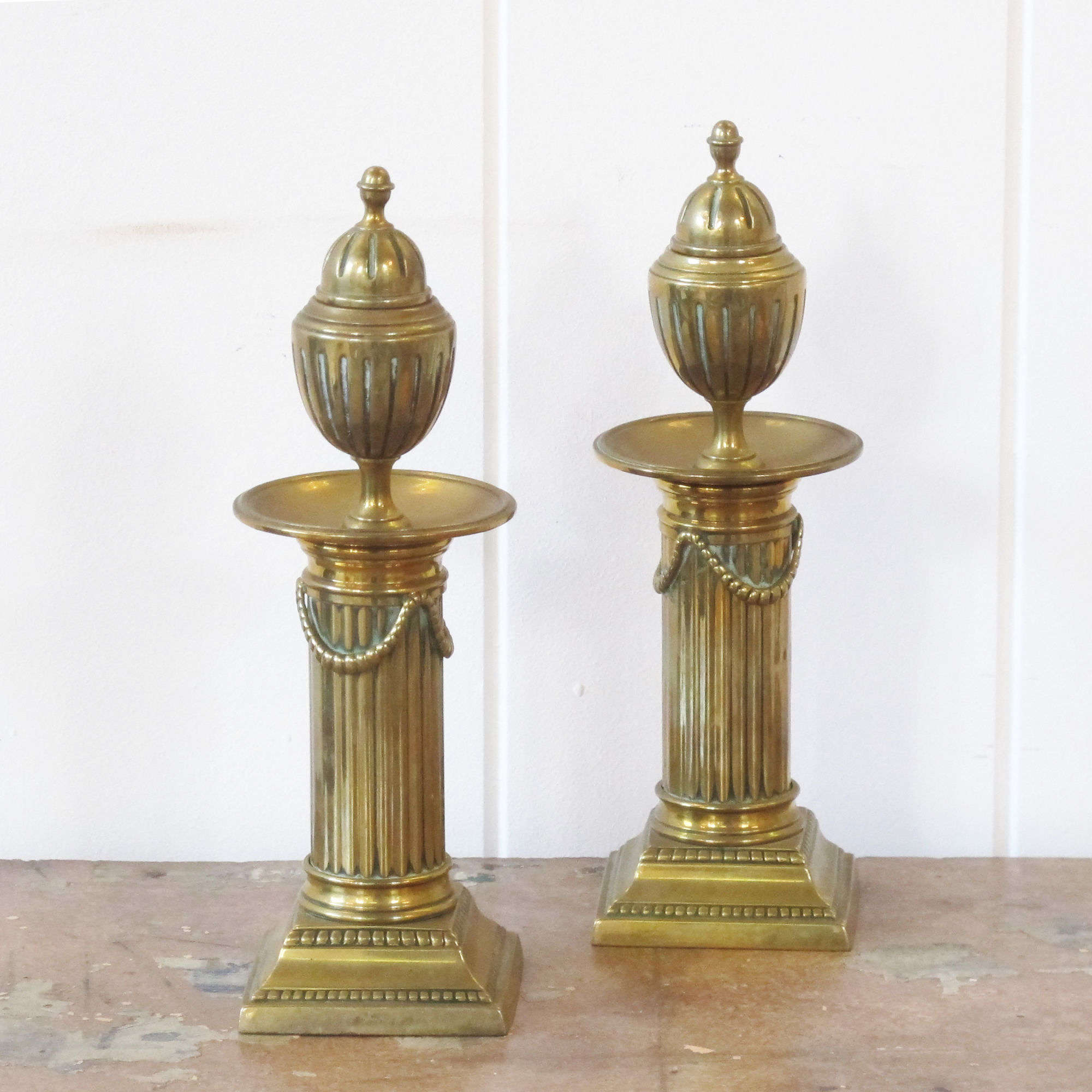 Decorative pair of brass column candlesticks.