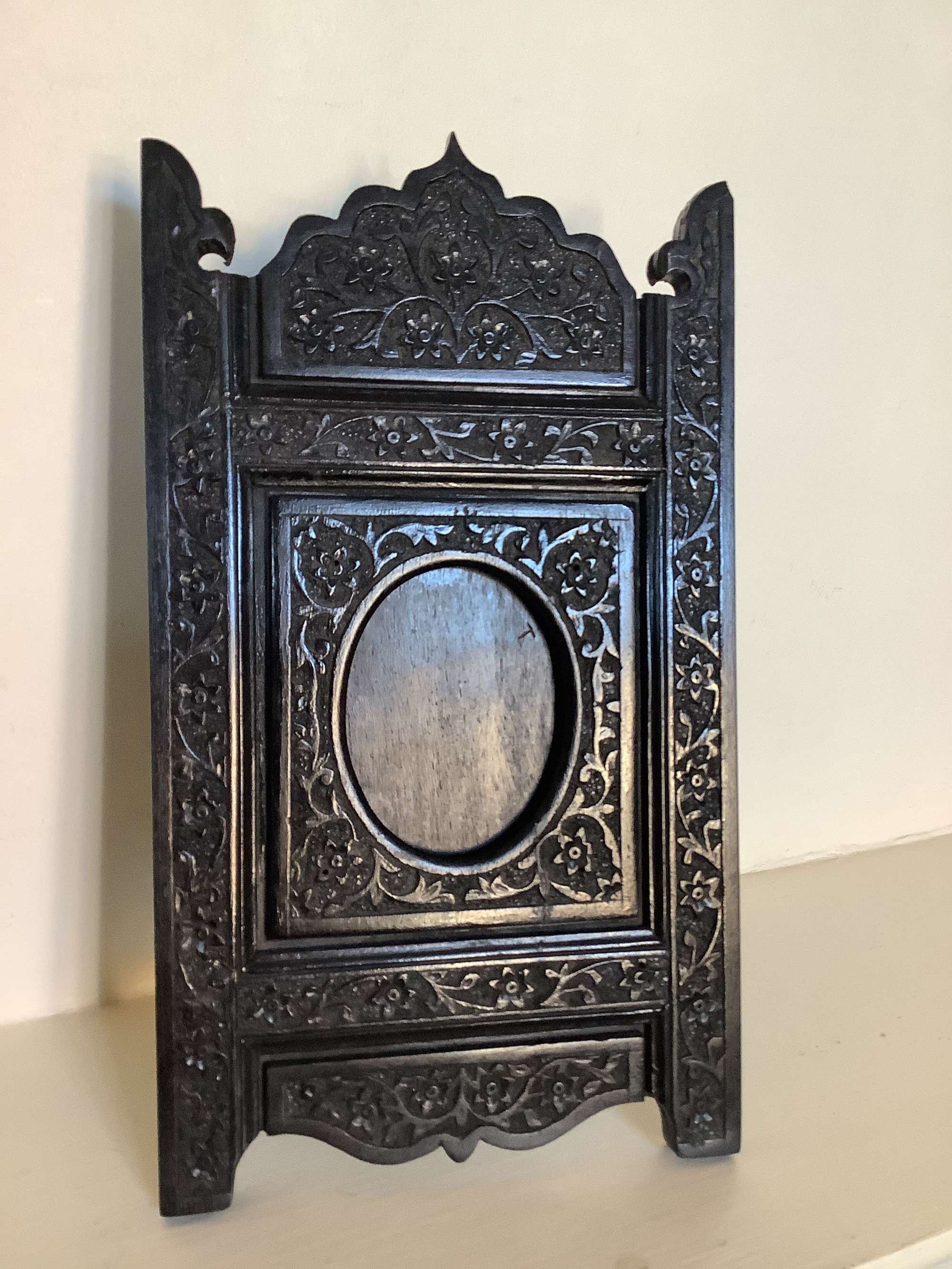 A very finely carved solid ebony Indian photo frame