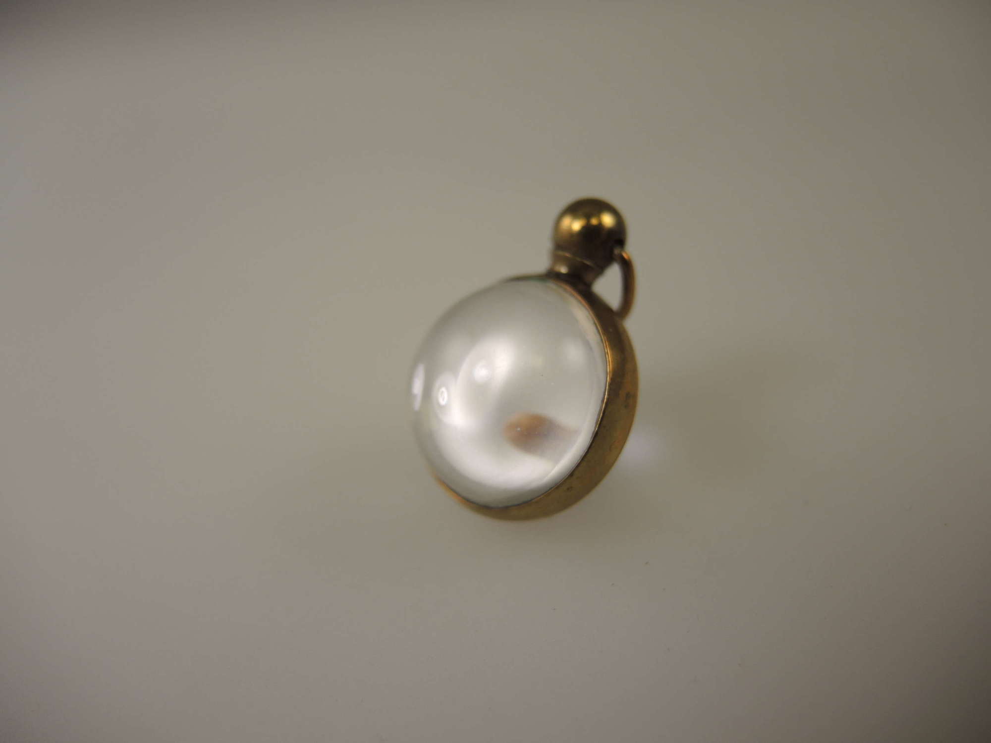 Gilt and glass ball locket c1890