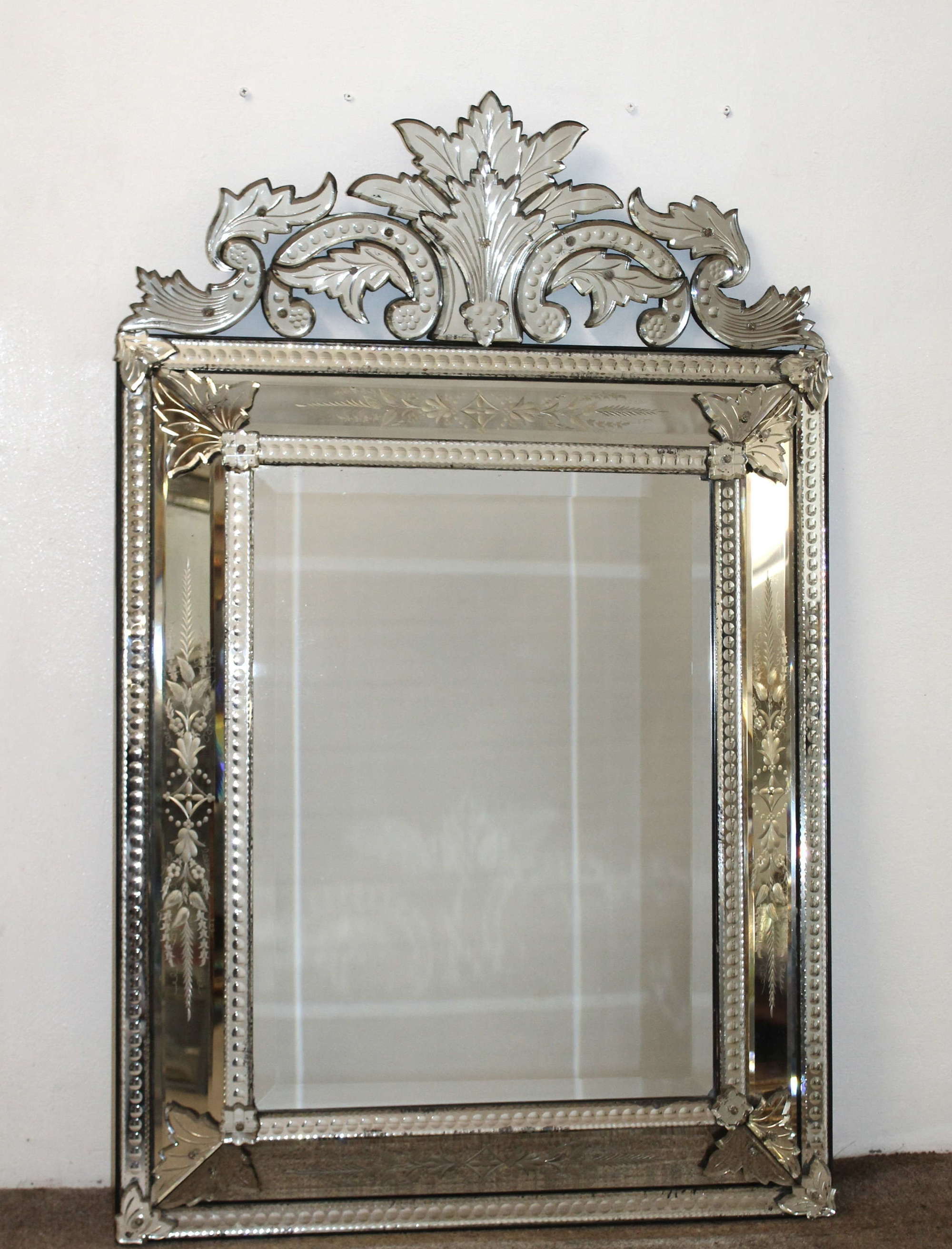 Antique cushioned Venetian mirror with acanthus cartouche