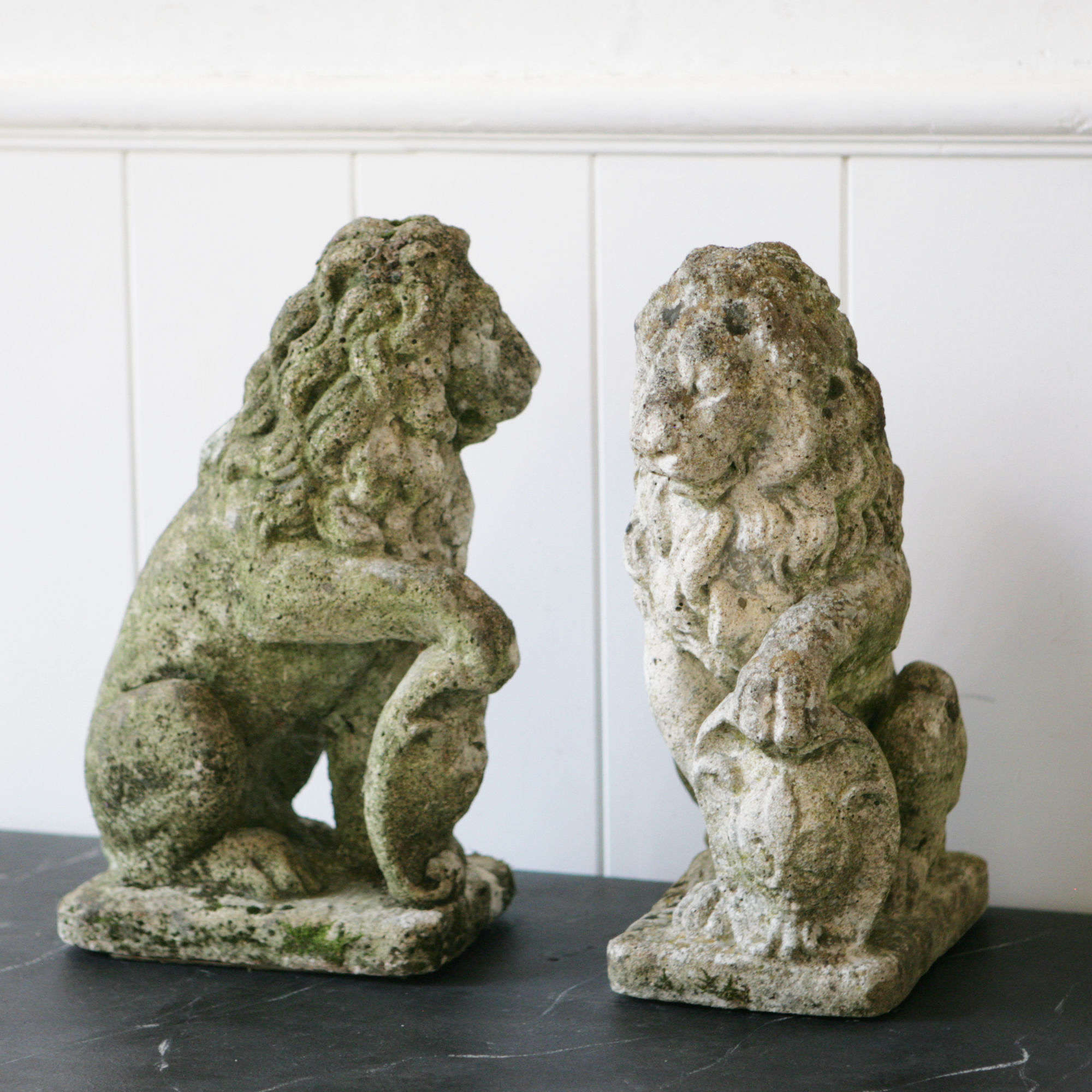 Pair stone lions with shields.