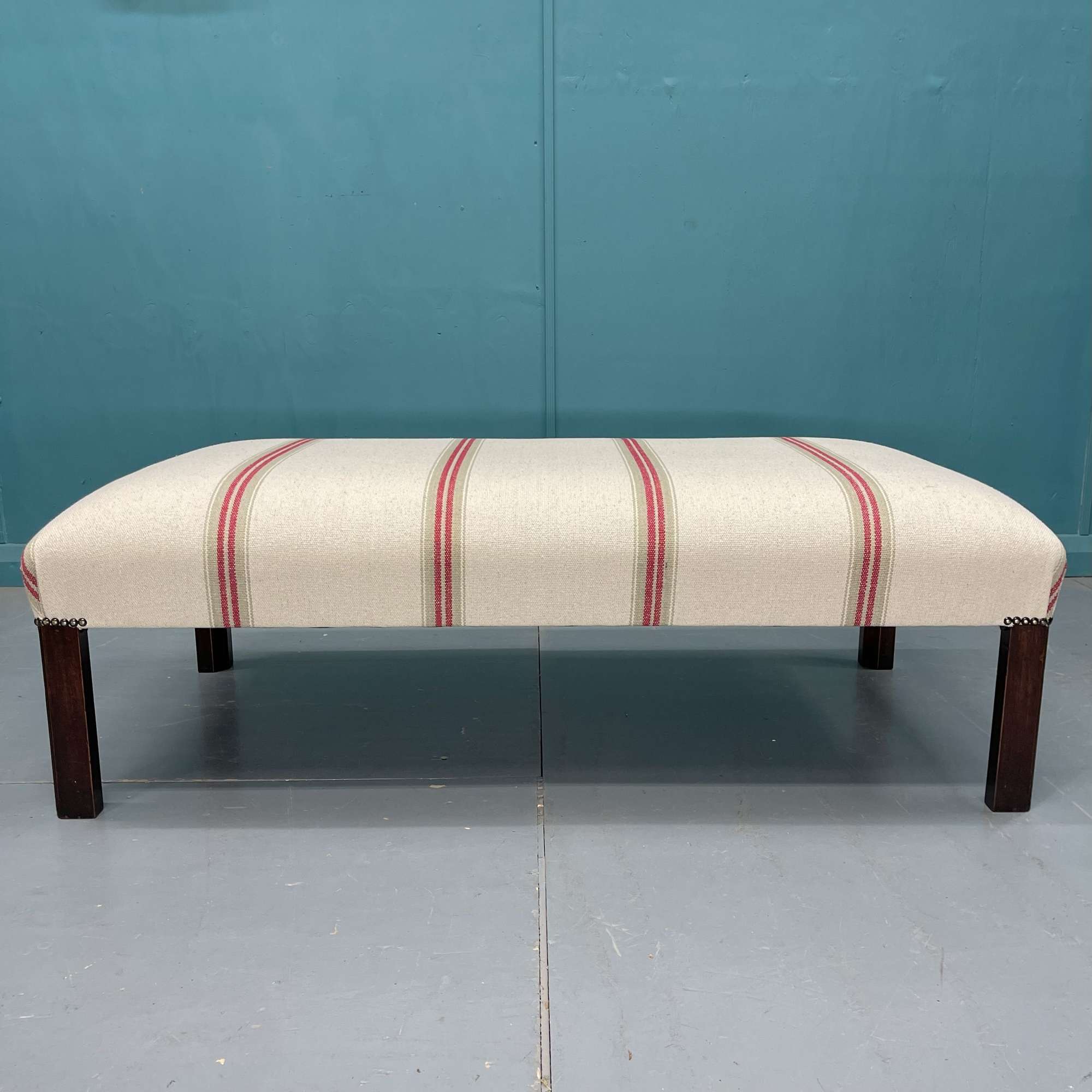 Newly upholstered heavy ticking stripe footstool