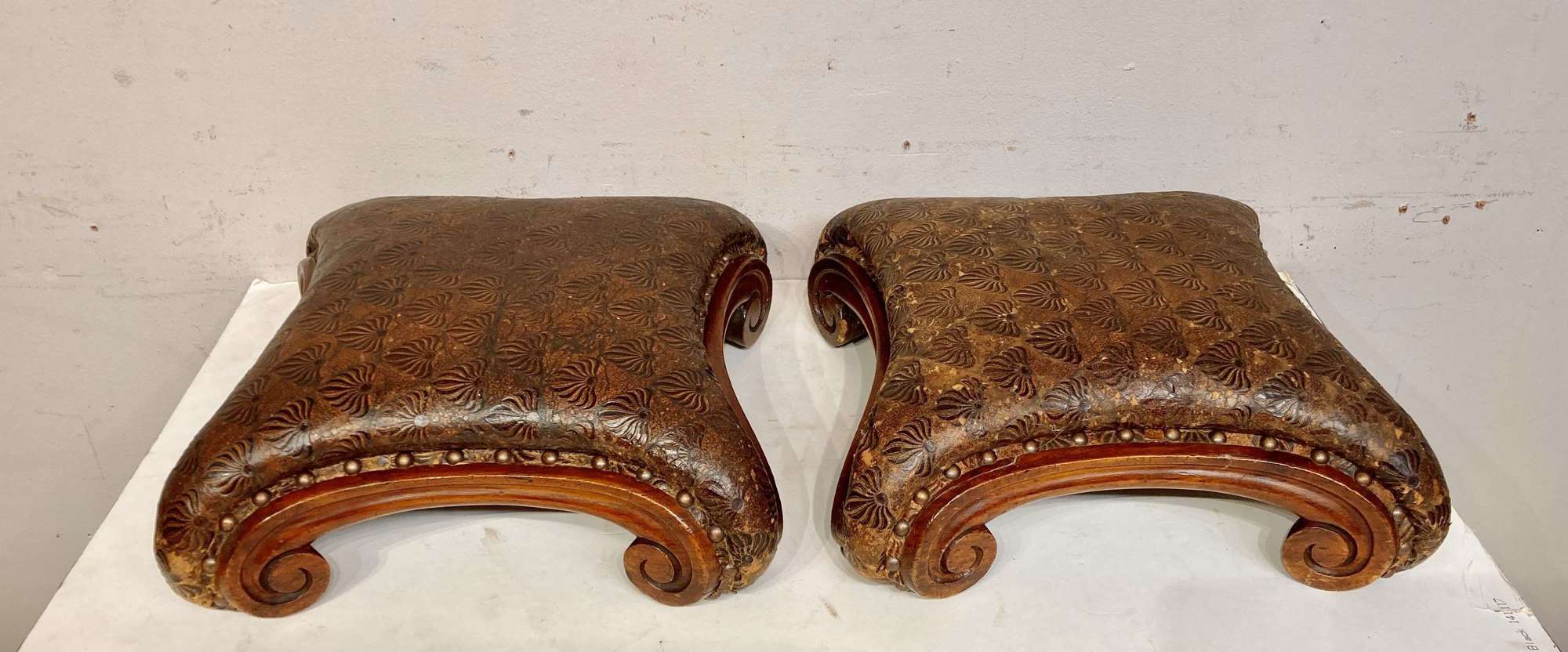Pair of William IV carved mahogany footstools.