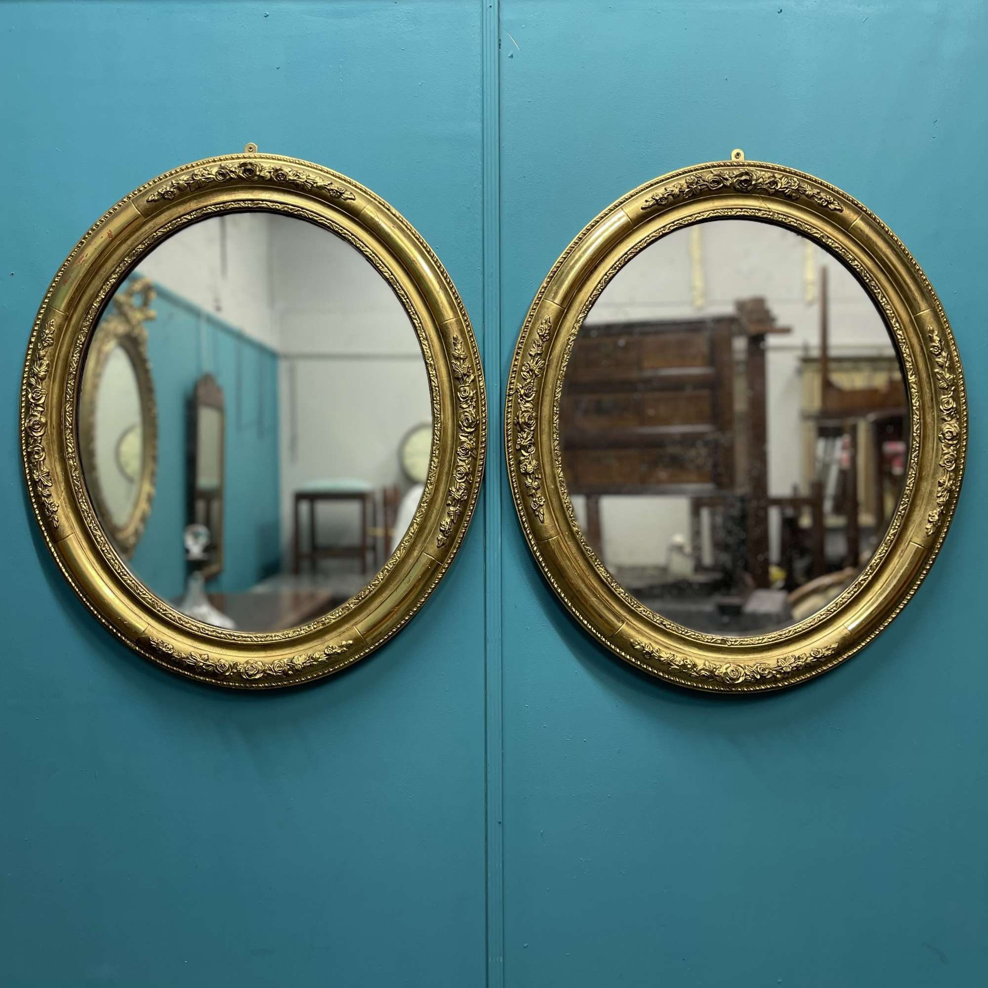 Large pair of French gilt oval mirrors