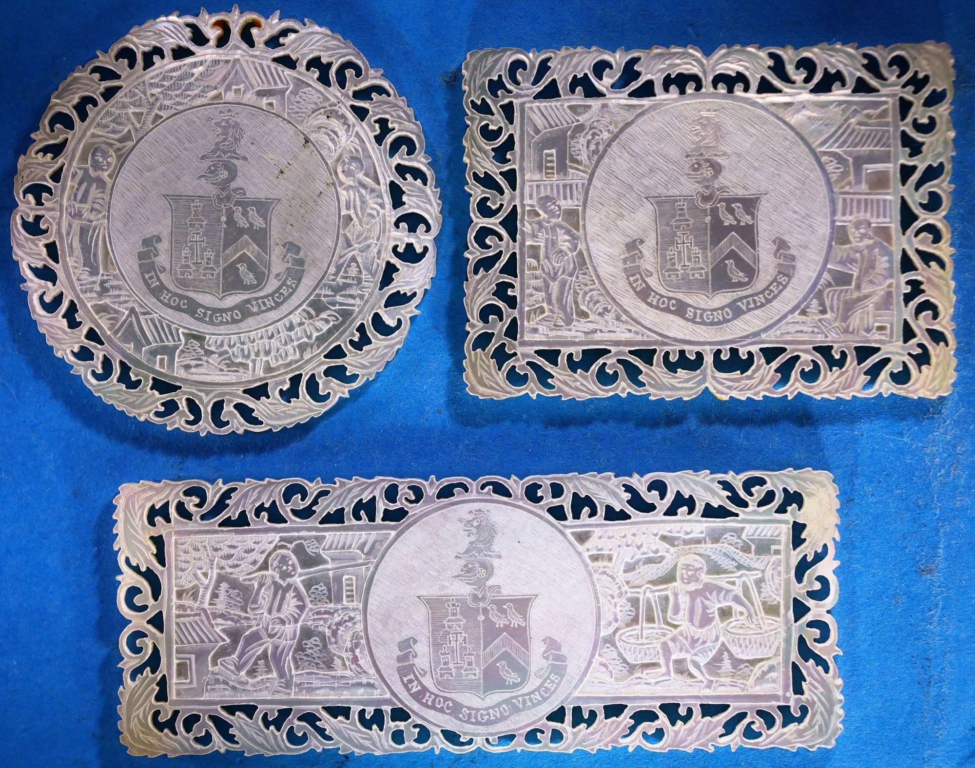 Set of three deep-carved fretted armorials
