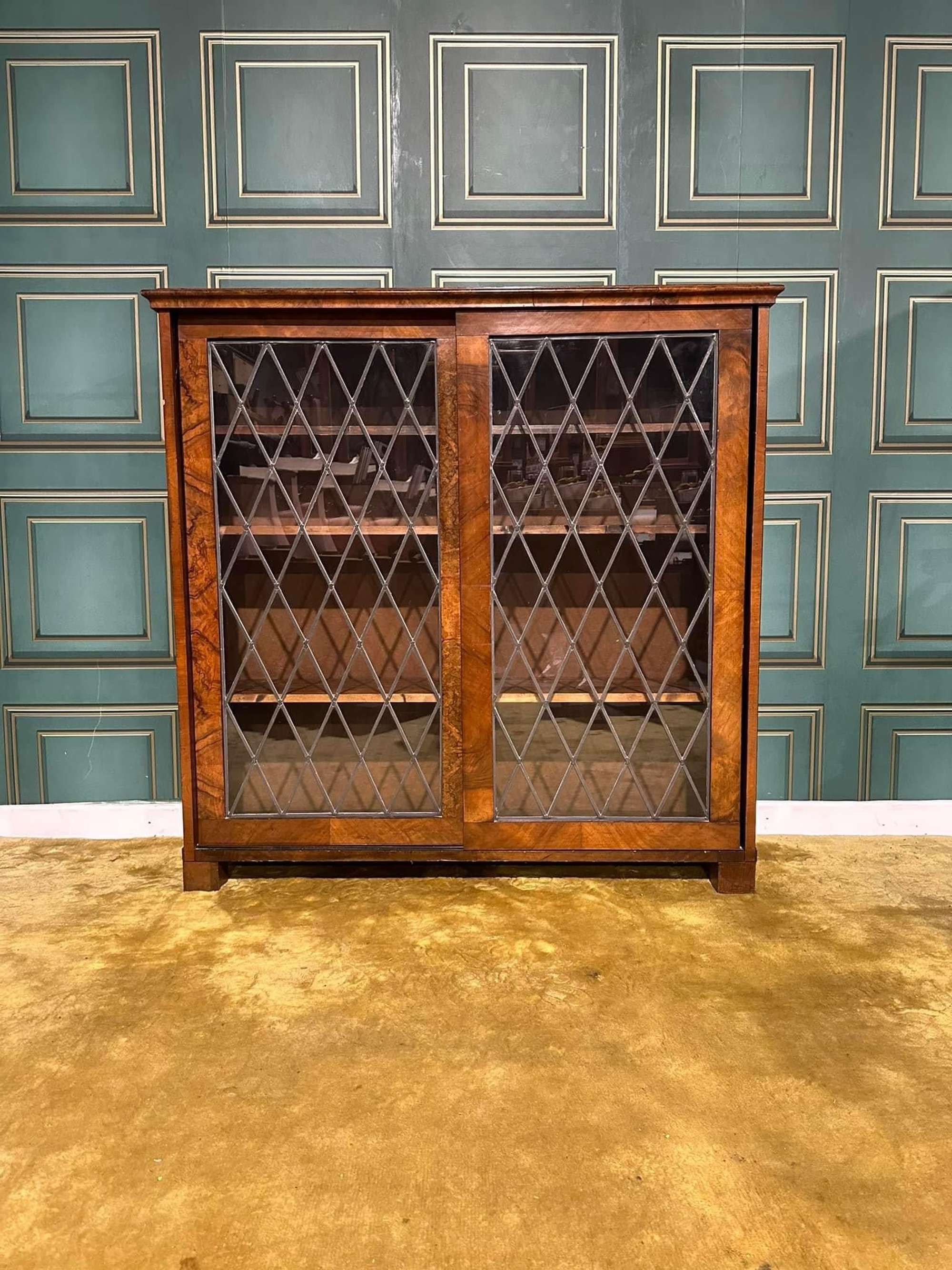 Vintage Walnut Leaded Glazed Sliding Door Bookcase Having Three Wooden Adjustable Shelves.