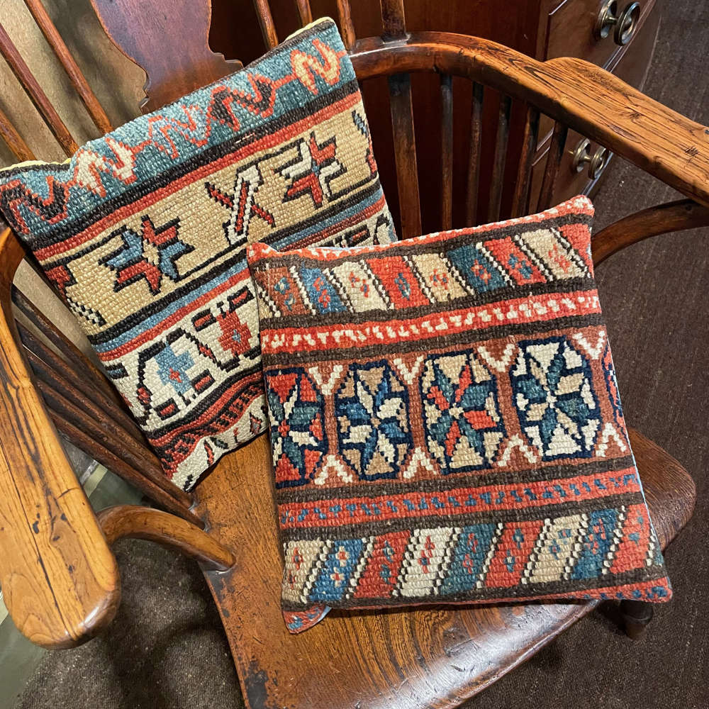 Two Cauasian rug fragments, now as cushions