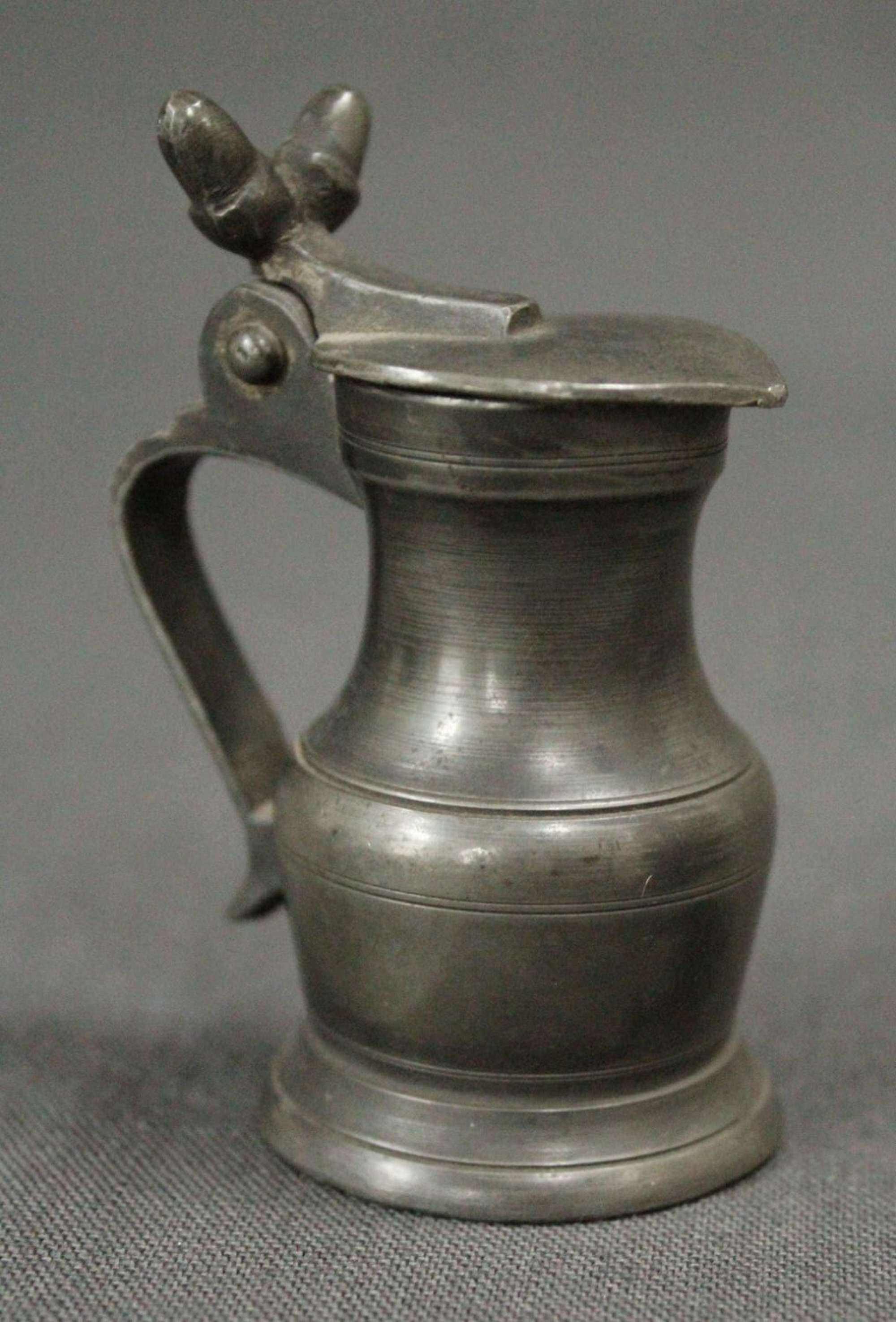 A small 19th Century pewter lidded measure