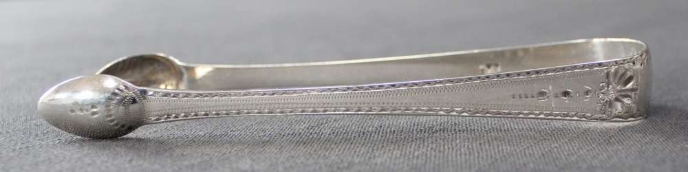 A pair of Geo. III bright cut silver tongs