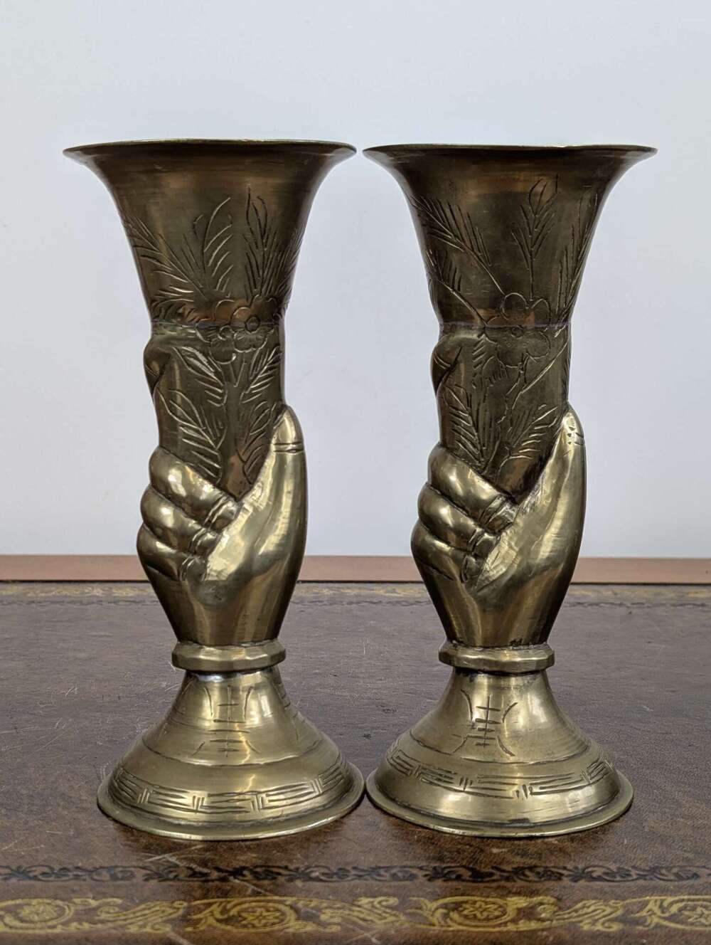 Pair of early 20th century Chinese brass vases, grasping hand motif, hand-engraved