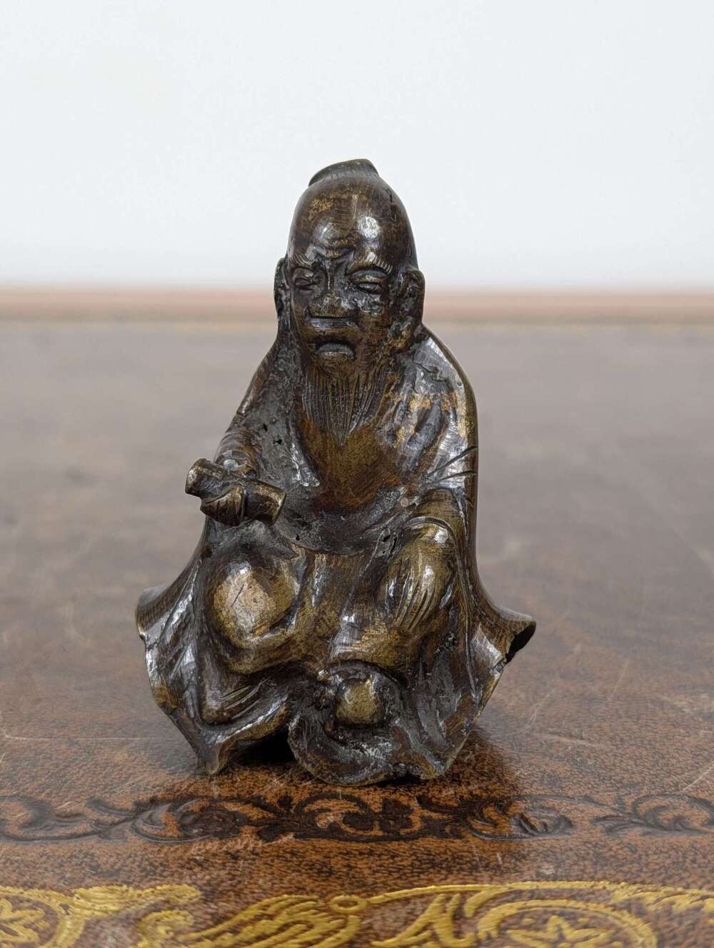 Chinese parcel-gilt bronze figure of Lu Dongbin with scroll, Ming to early Qing circa 1600
