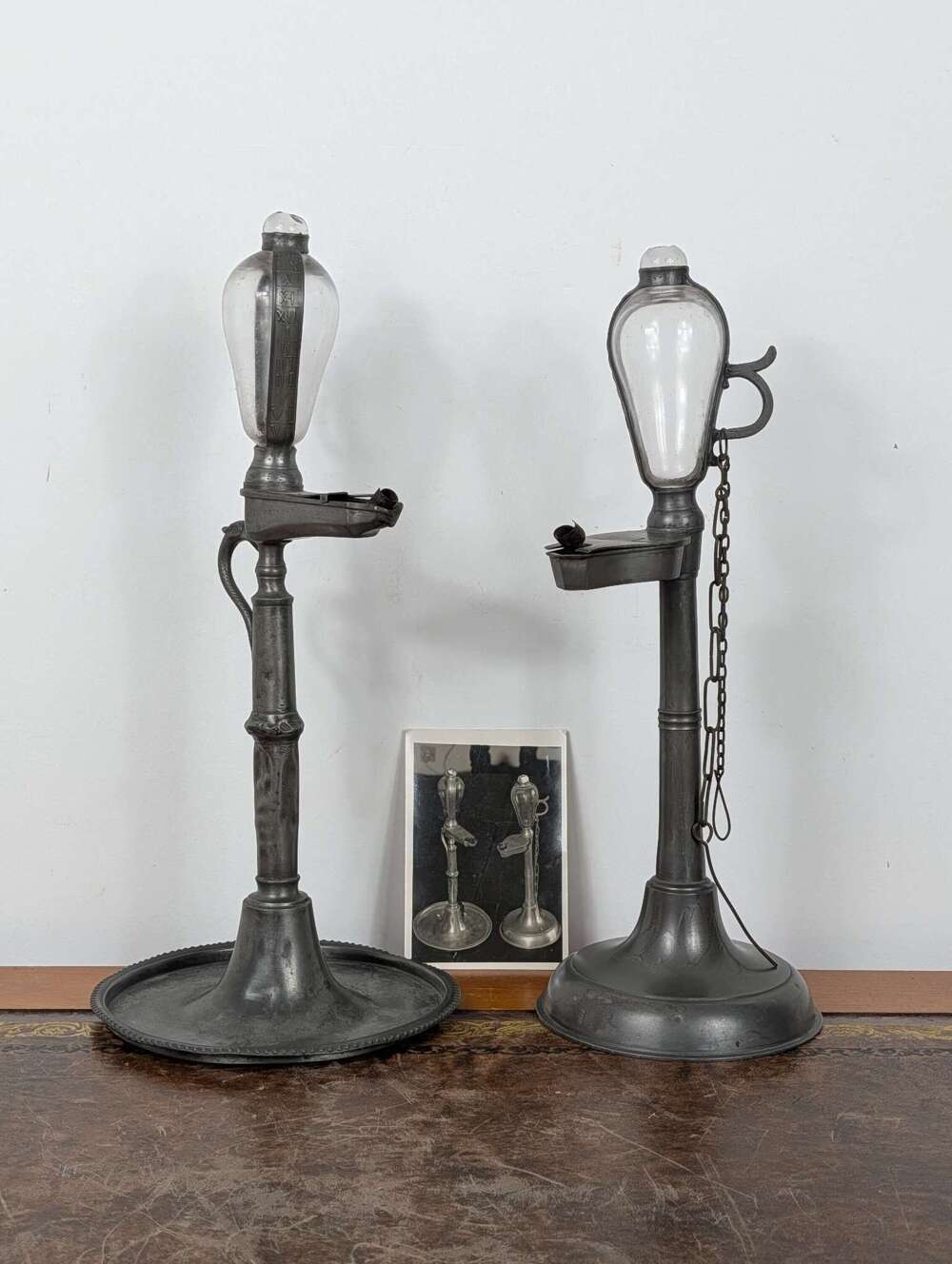 Pair whale oil lamp clocks with blown glass reservoirs & pewter hour straps, early 19th C