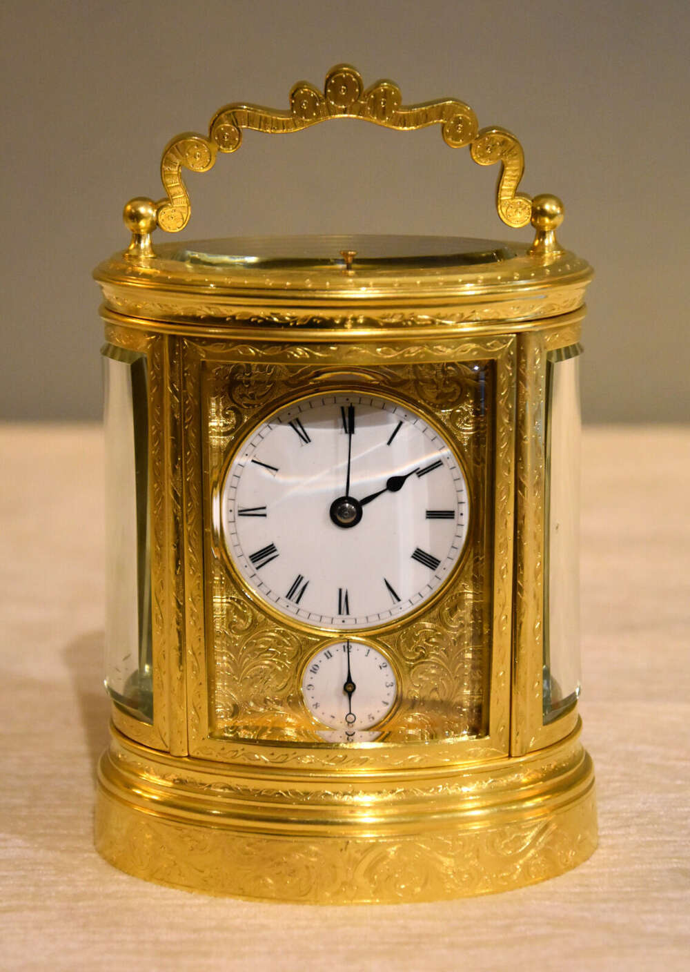 An engraved oval carriage clock
