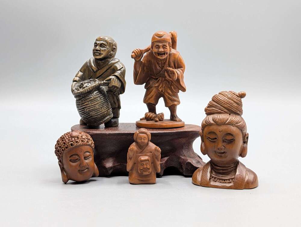 Japanese boxwood carved Buddha & character netsukes, group of 5 signed with hardwood stand