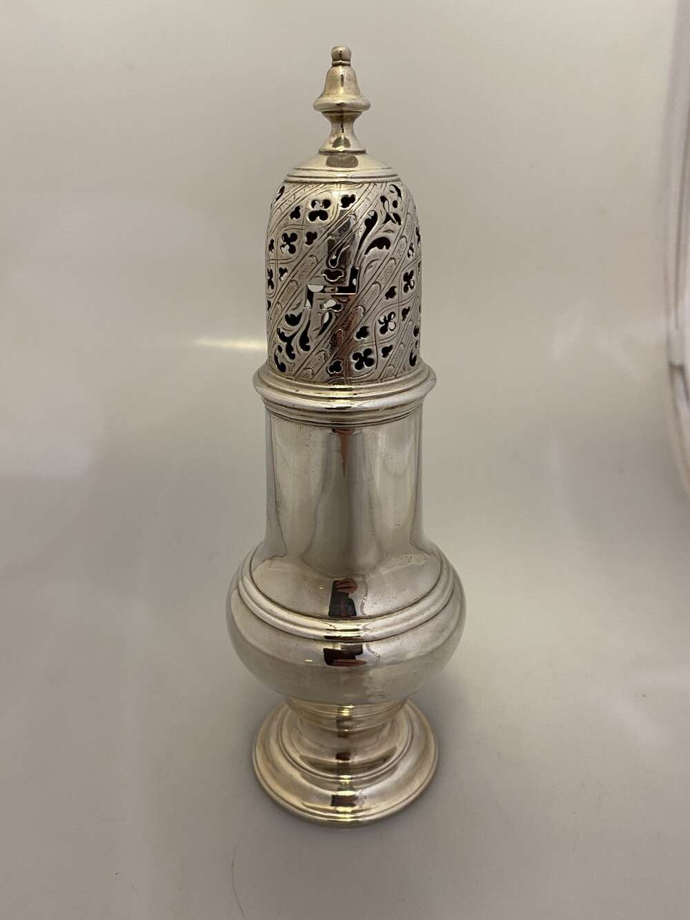 A George III silver sugar caster by Samuel Wood.