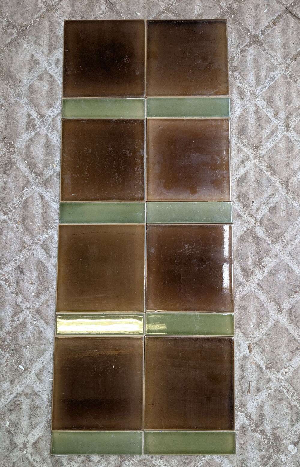 M2242 A SET OF SIXTEEN RECLAIMED ANTIQUE FIRE TILES GREEN AND BROWN