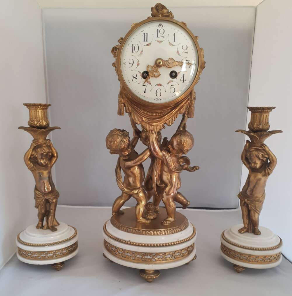 A Marble And Gilt Metal Clock Garniture