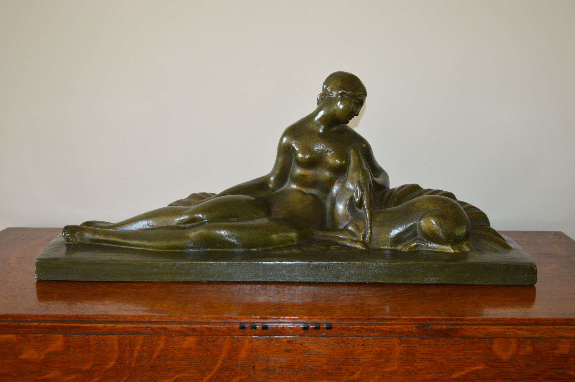 Art Deco figural group of a reclining lady with a deer