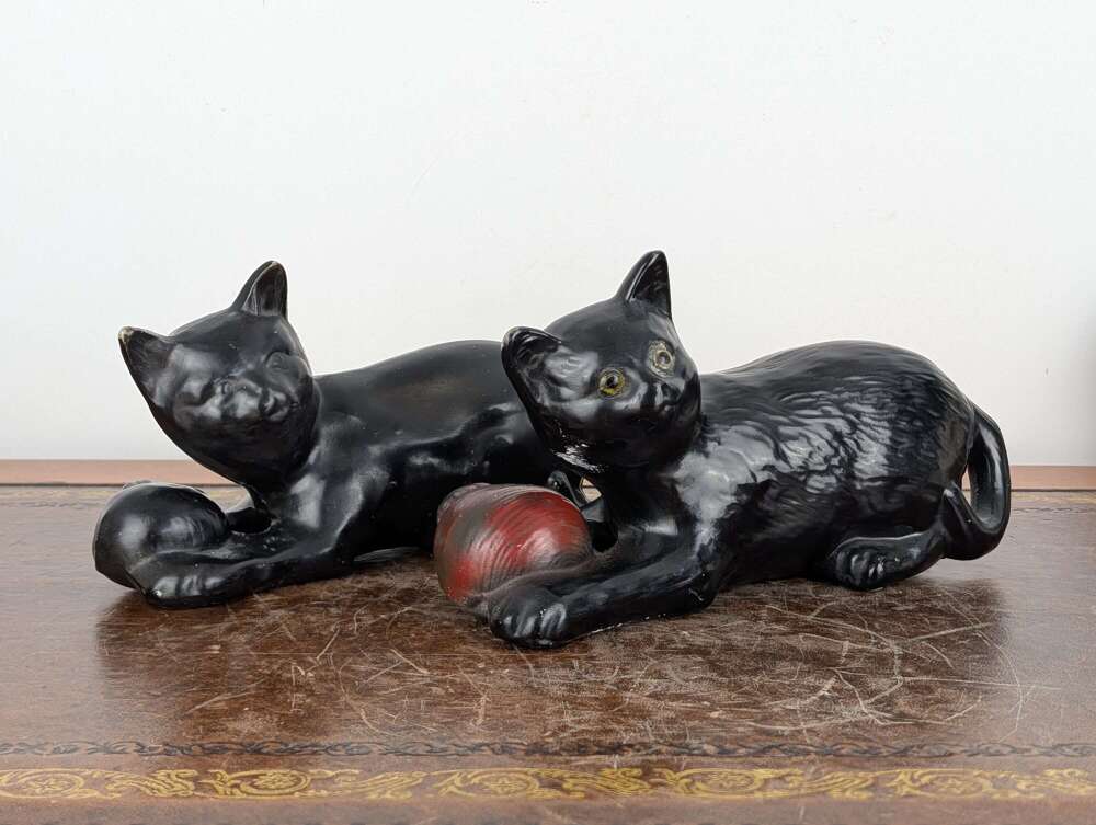 Two black Staffordshire cat figures, both marked, early 20th Century