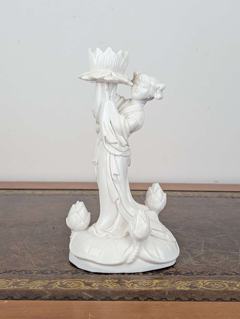 Chinese Blanc de Chine porcelain He Xiangu figure with lotus flower