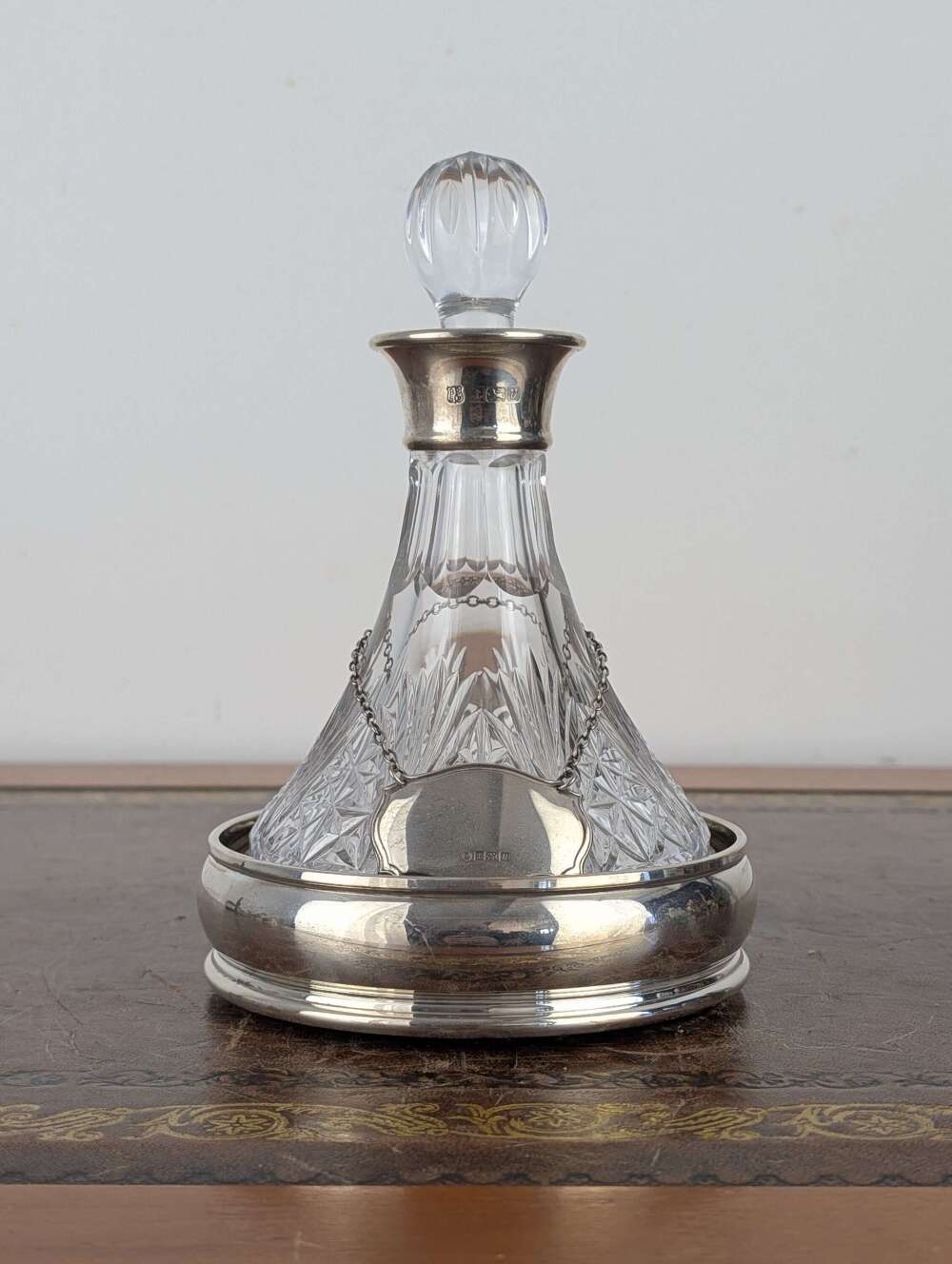 Cut glass ships decanter with silver collar, label and coaster, England 1995