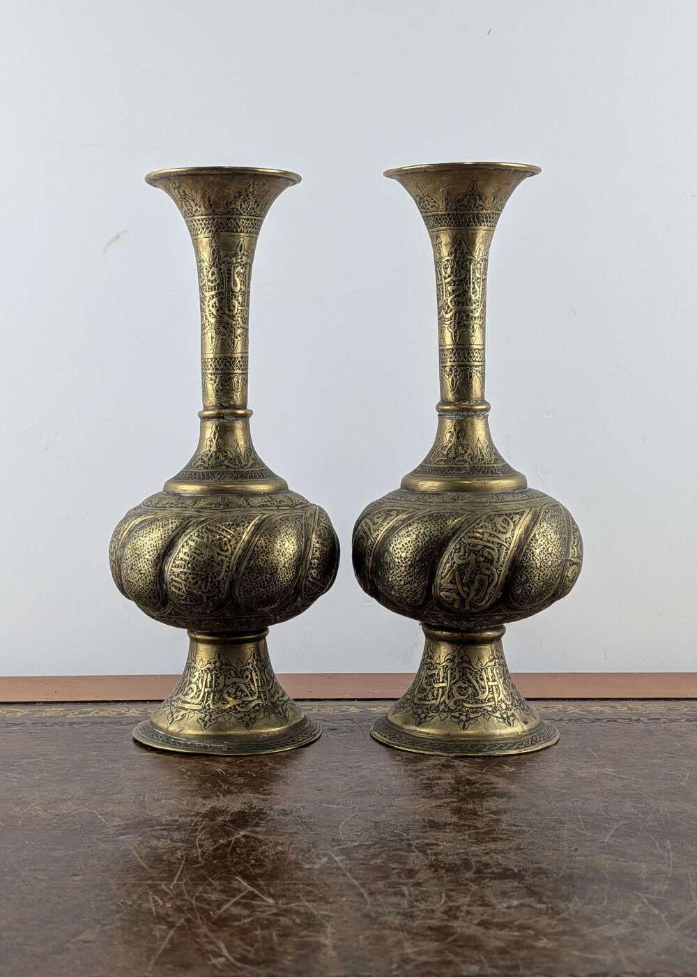 Pair of Qajar Persian brass engraved vases with Islamic calligraphy, 19th century