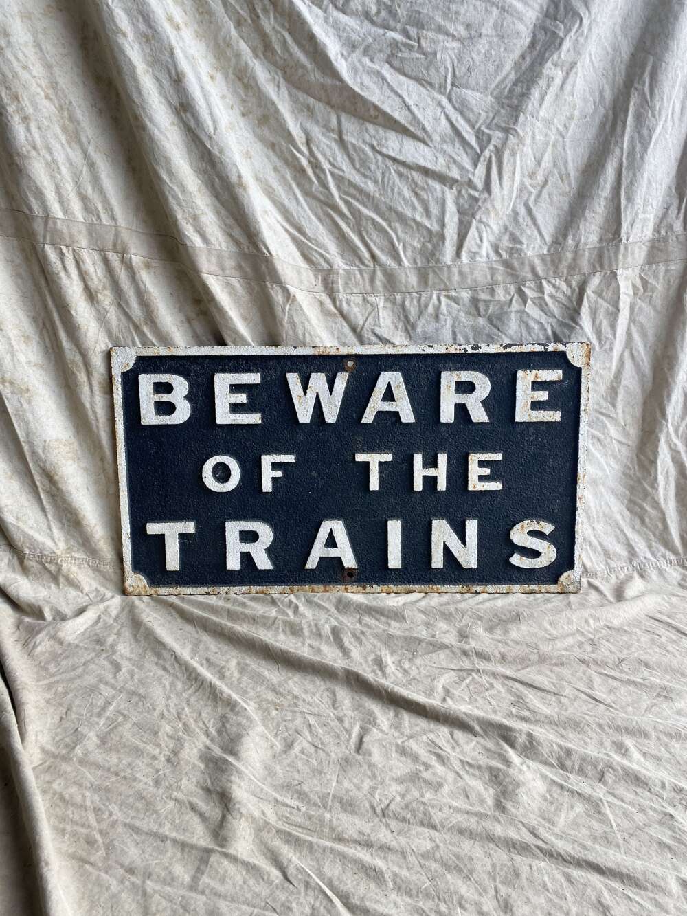 An antique cast iron railway sign