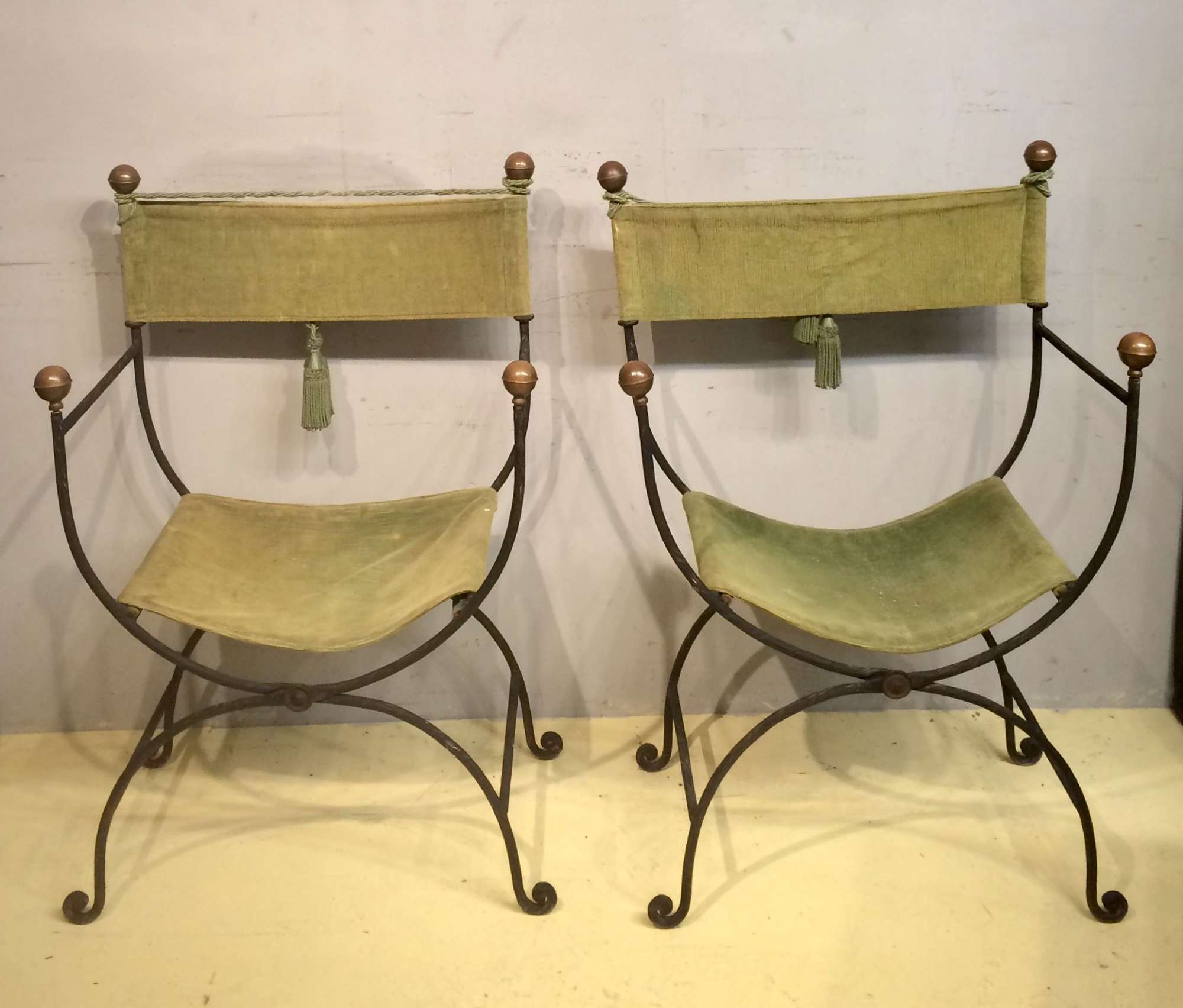 A pair of Spanish decorative iron folding chairs.