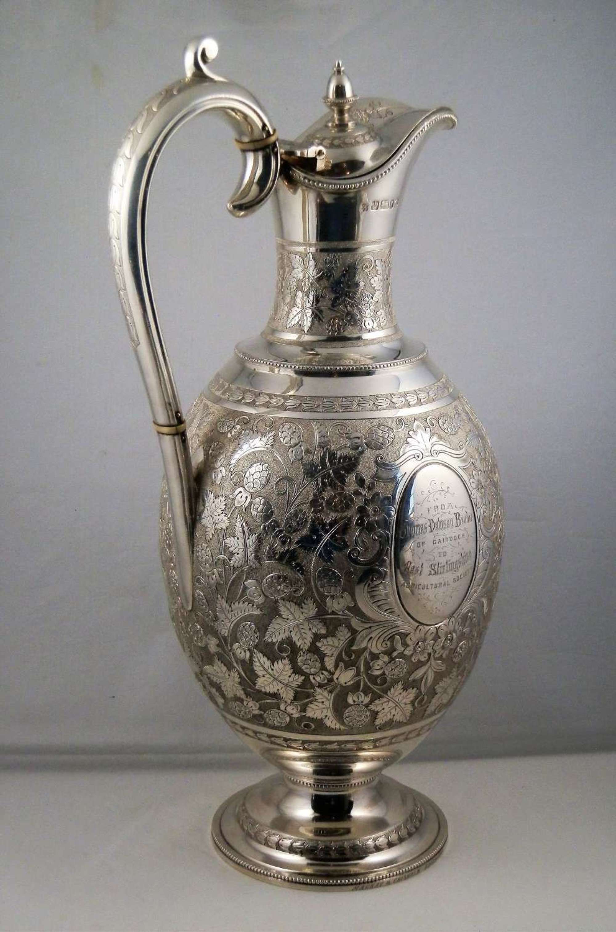 An ornate Victorian silver presentation claret jug, 1877