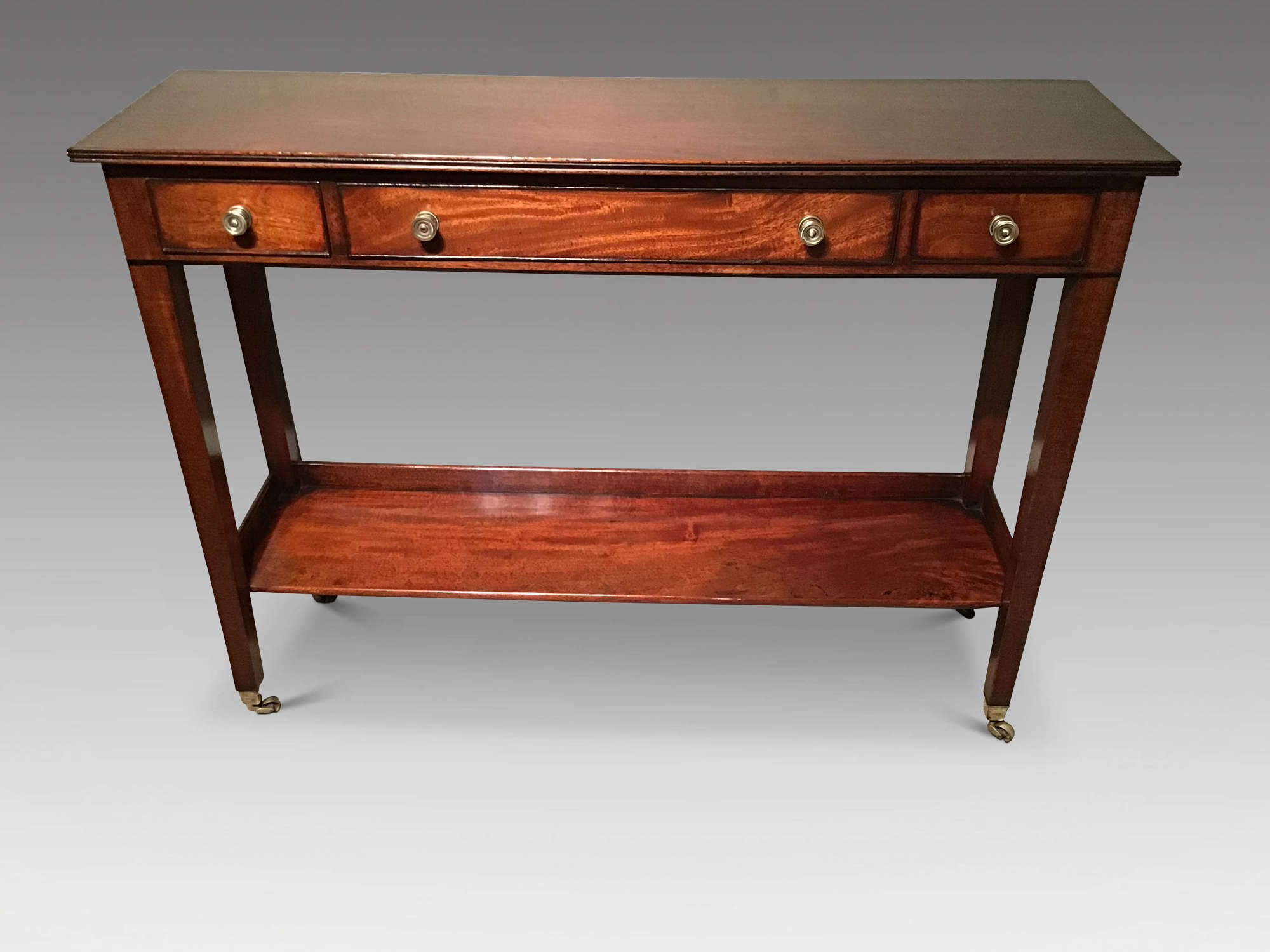 Shallow antique mahogany two tier sidetable.