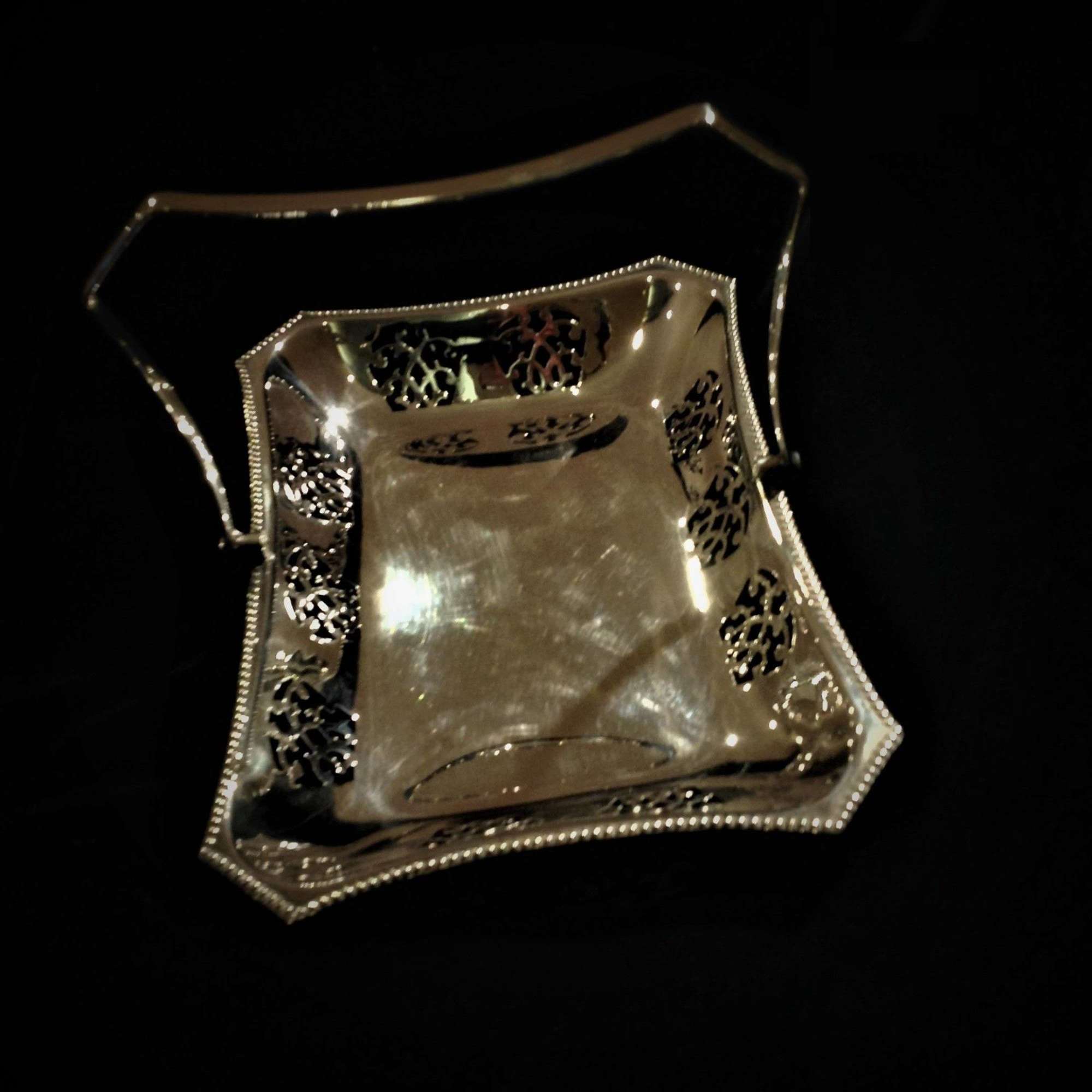Decorative silver plated swing-handled basket