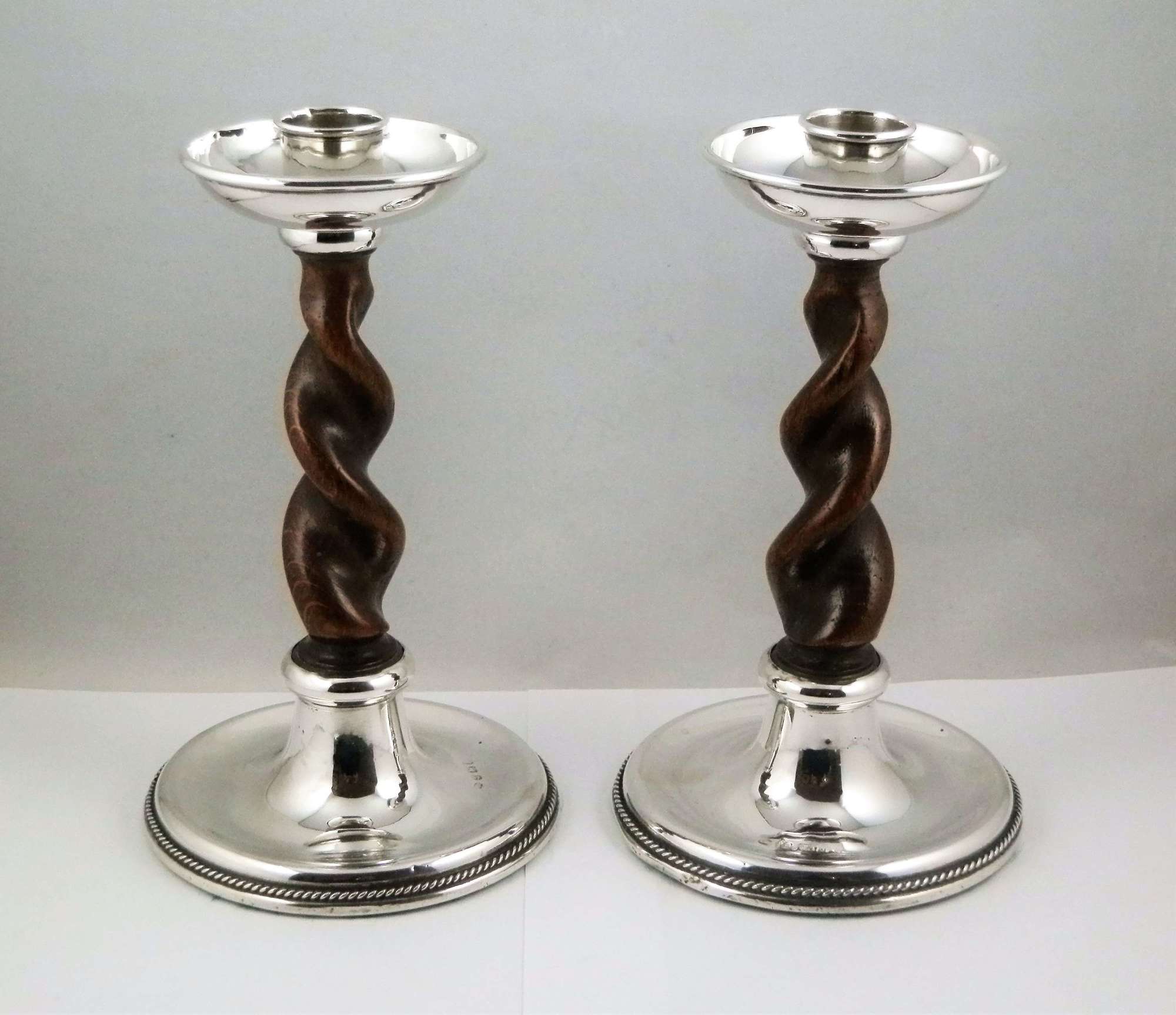 An arts and crafts pair of barley twist silver candlesticks, A. E. Jo