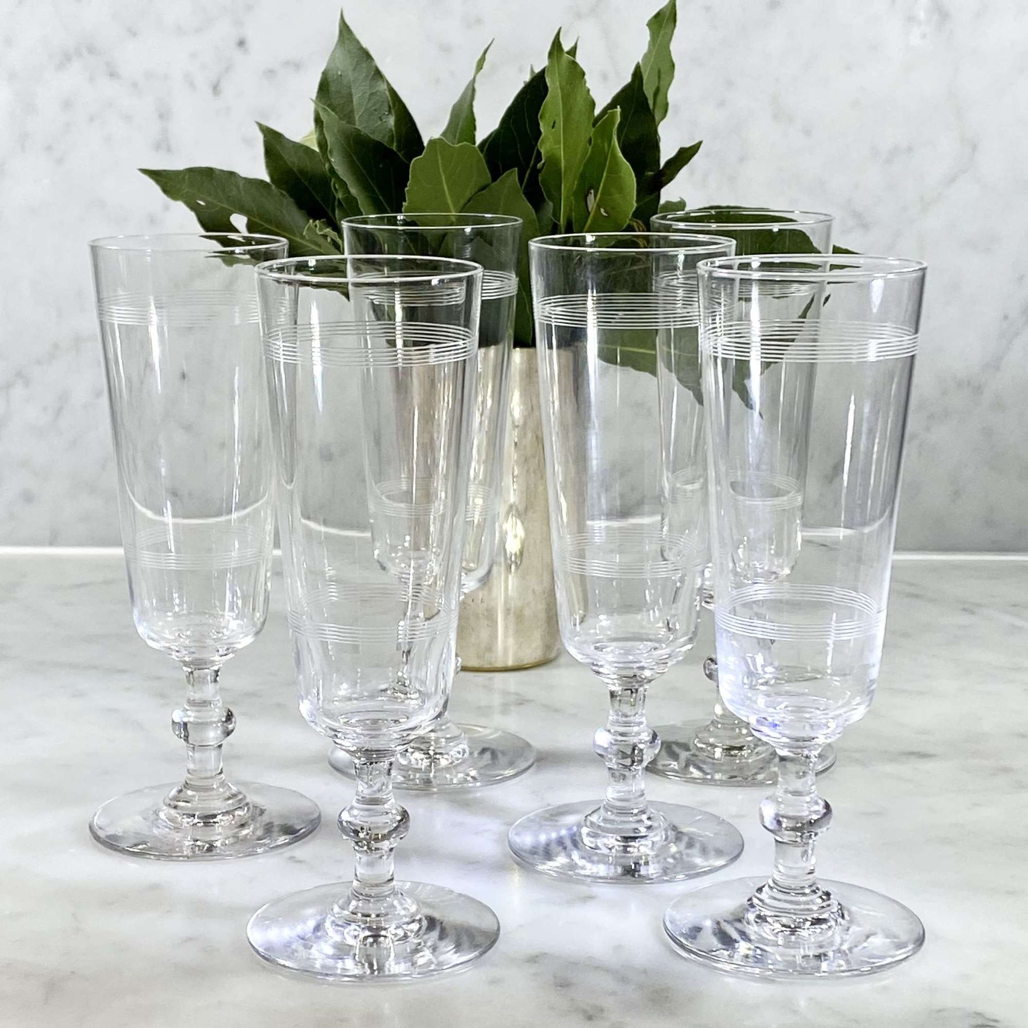 Six Art Deco etched crystal flutes attributed to Baccarat