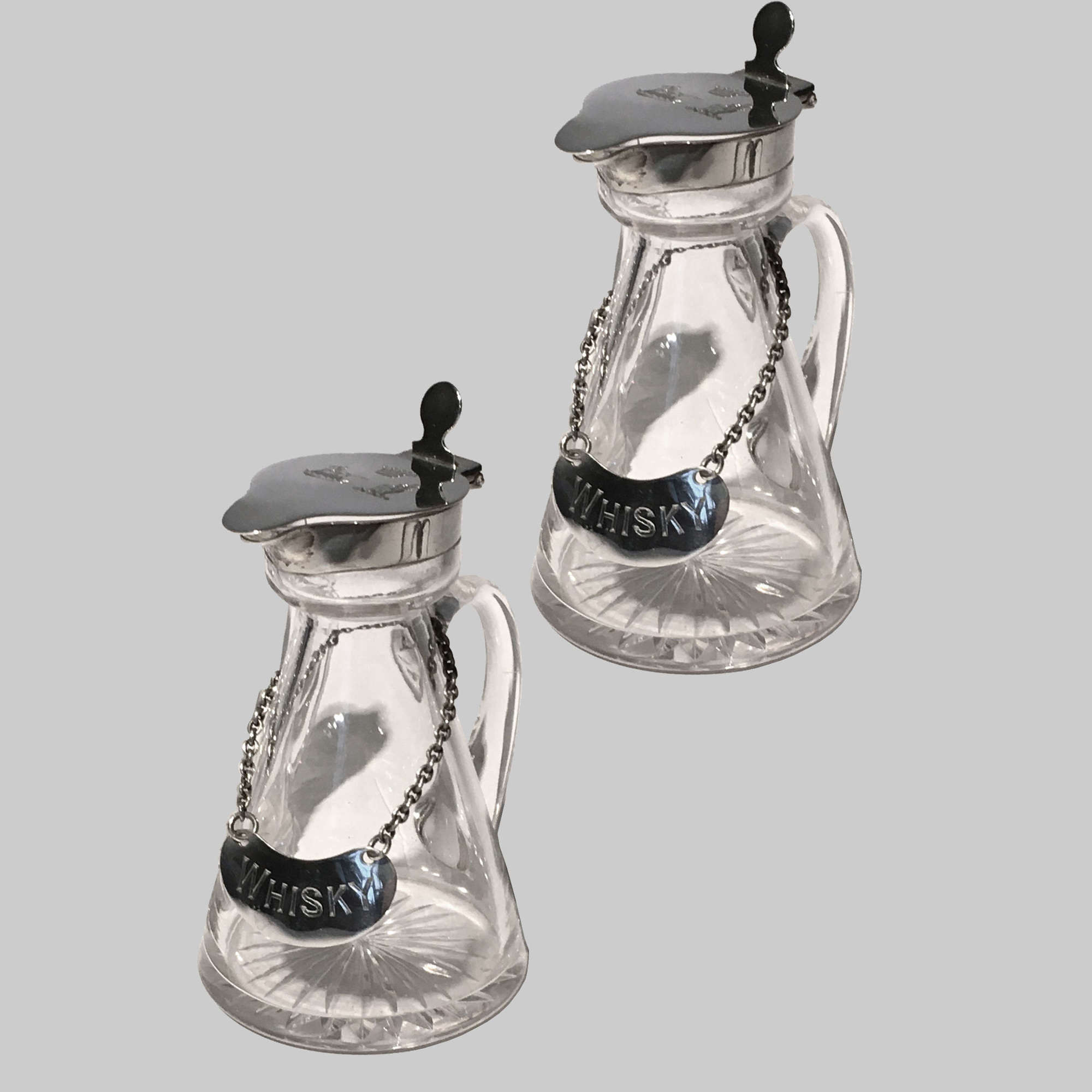 Pair of silver mounted glass whisky noggins by Hukin & Heath
