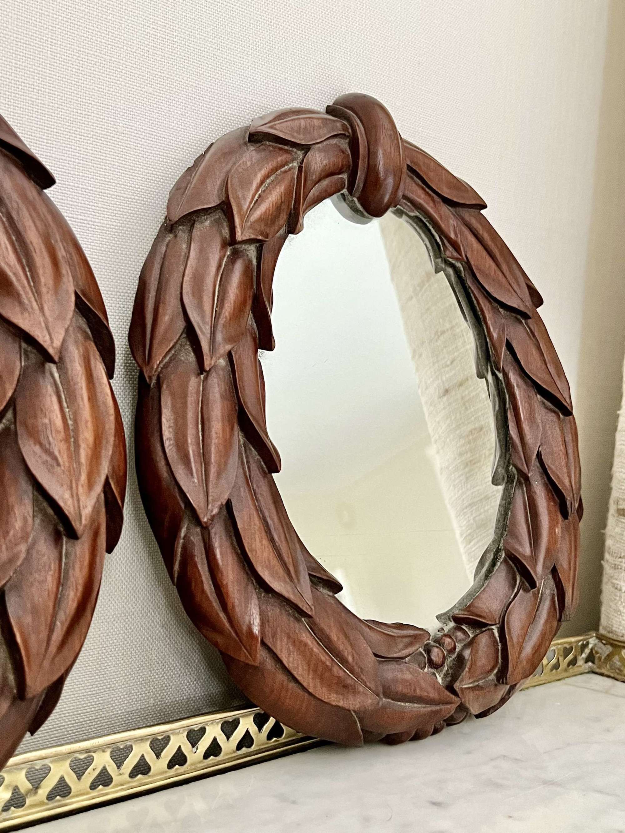 Pair of William IV carved mahogany laurel wreath mirrors