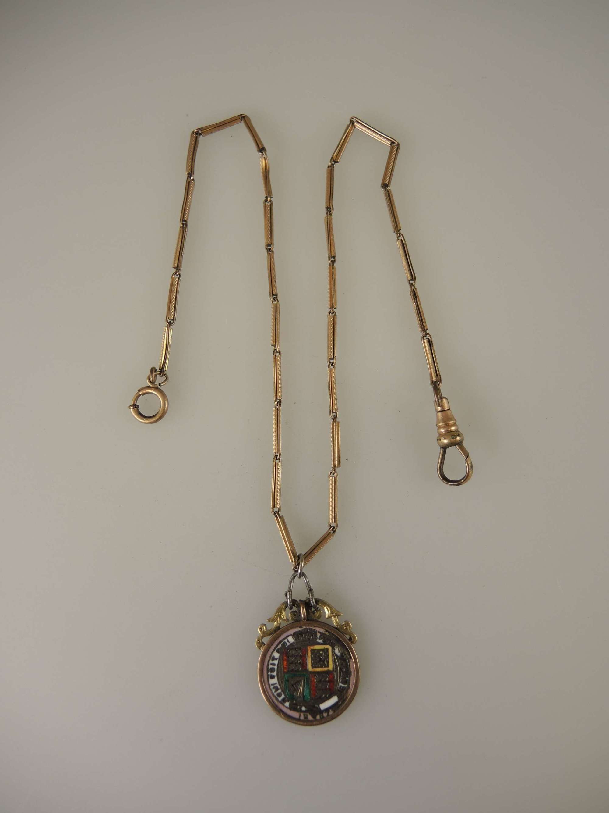 Single pocket watch chain with an enamel coin fob c1890