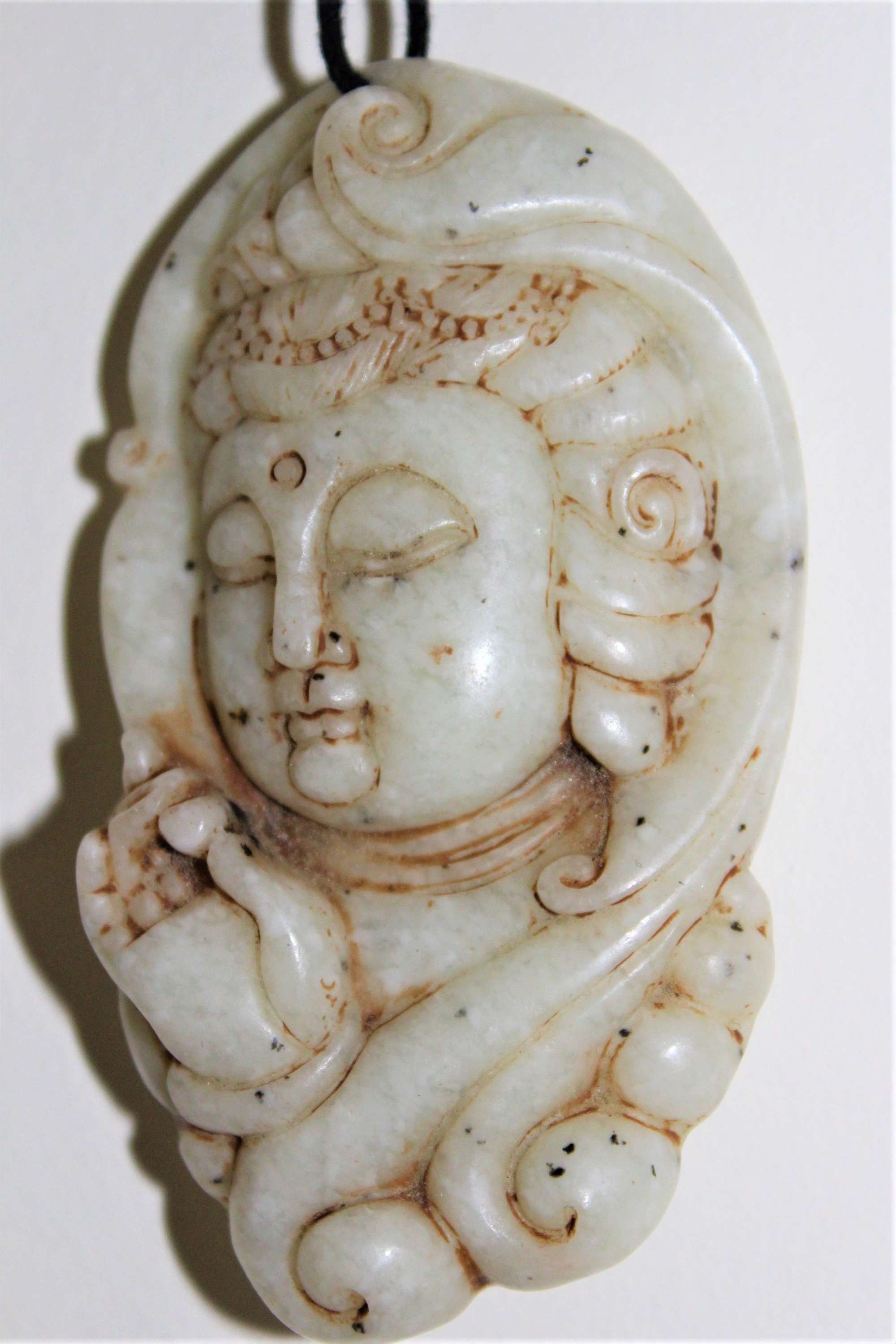 A Finely Carved Chinese Jade Pendant Of A Deity Circa 1880to1920