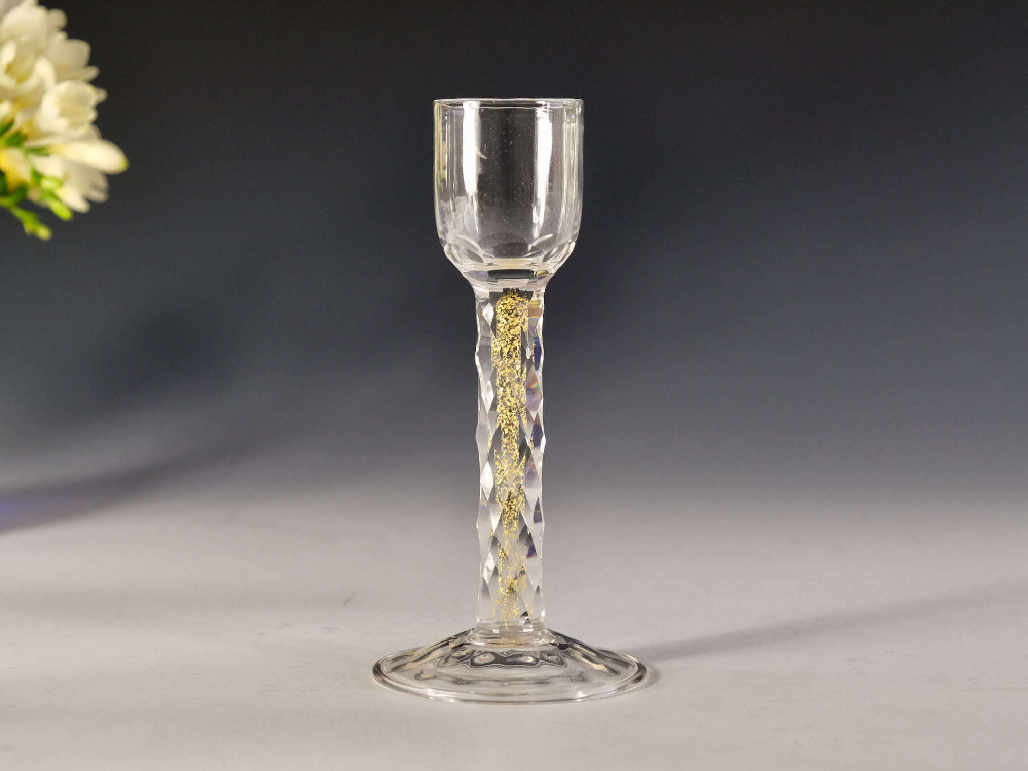 Liqueur glass the facet cut stem with gold foil inclusions C1900