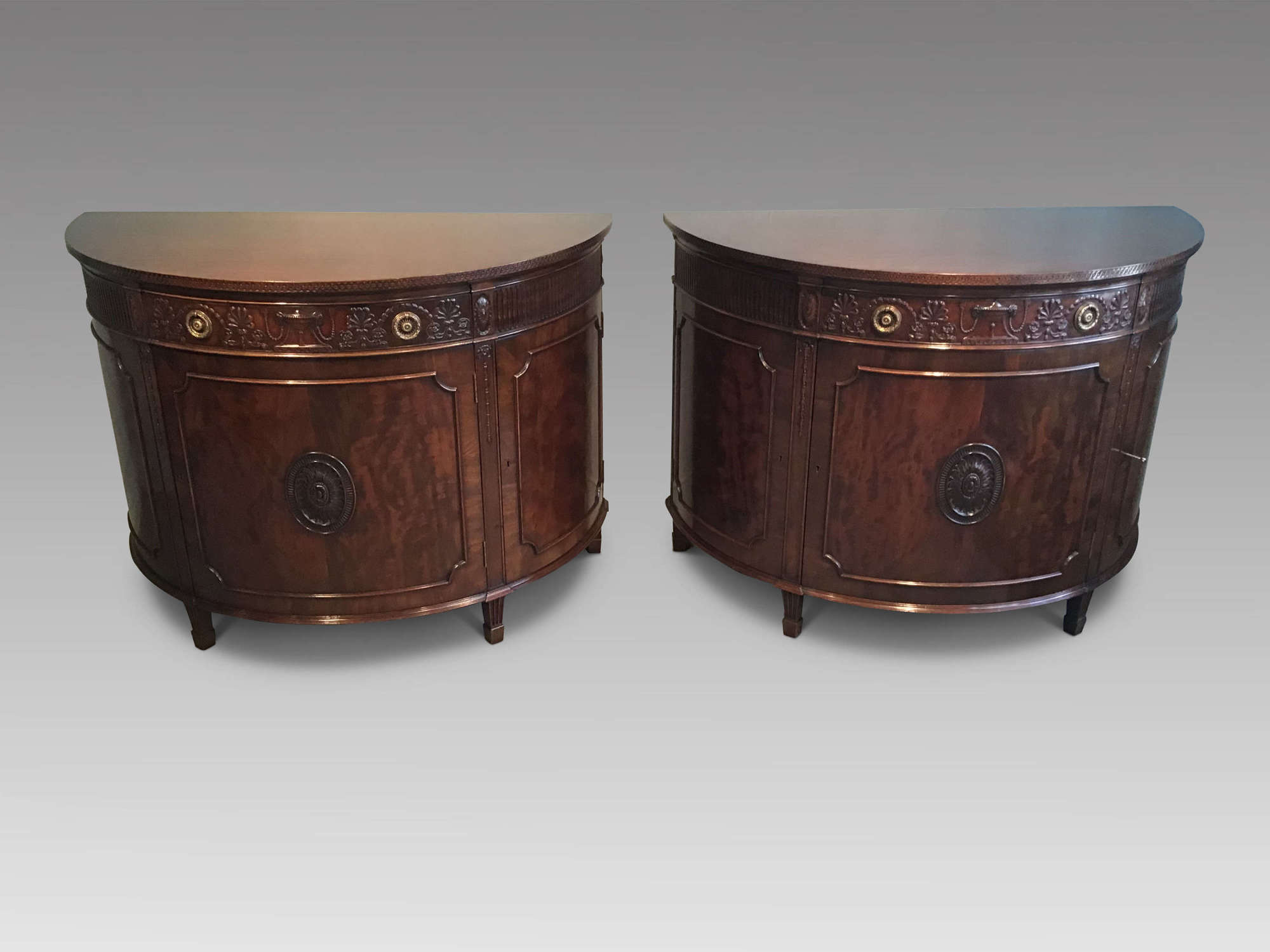 Pair of mahogany demi-lune commodes