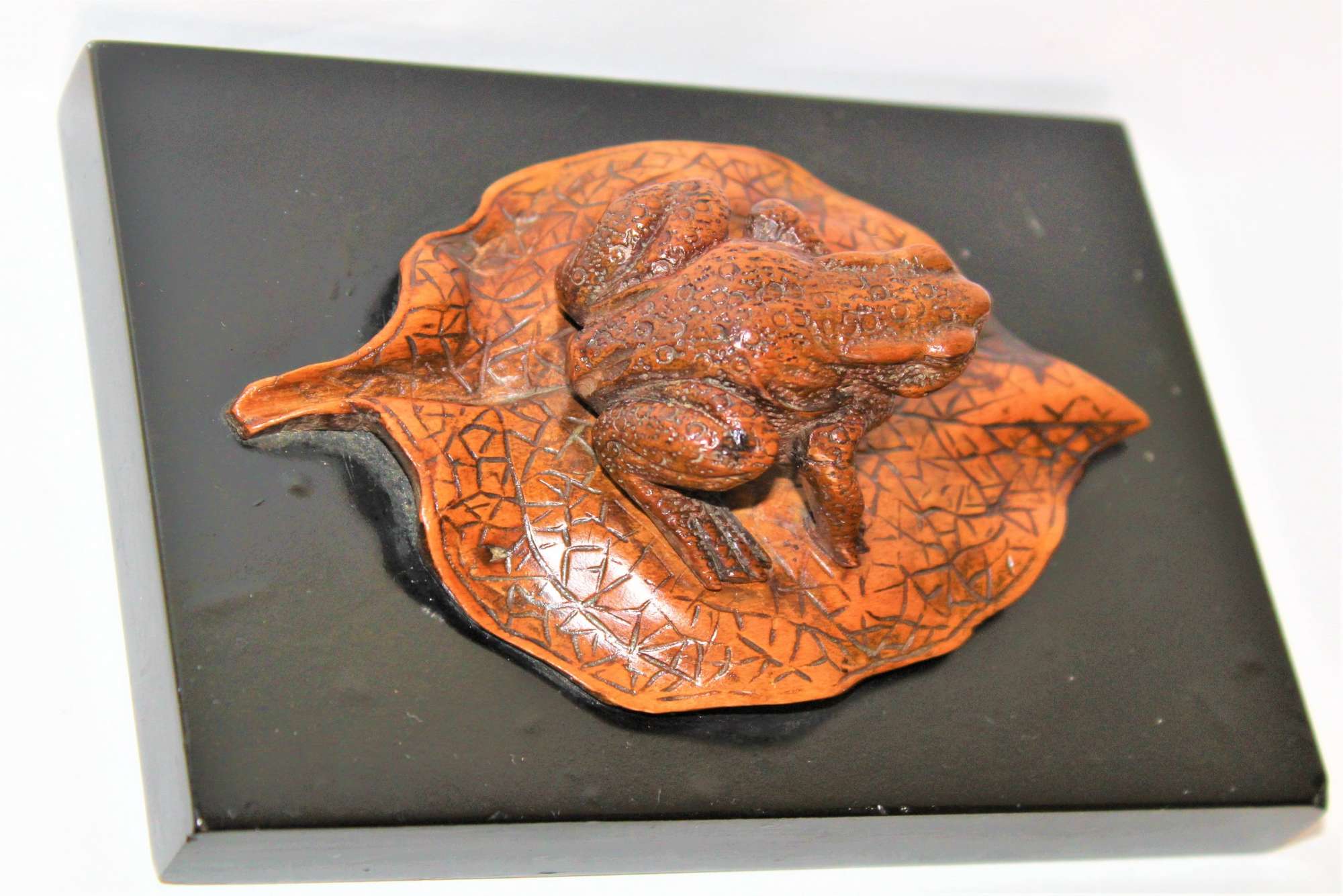 A charming and well carved Japanese wood paper weight of a Toad