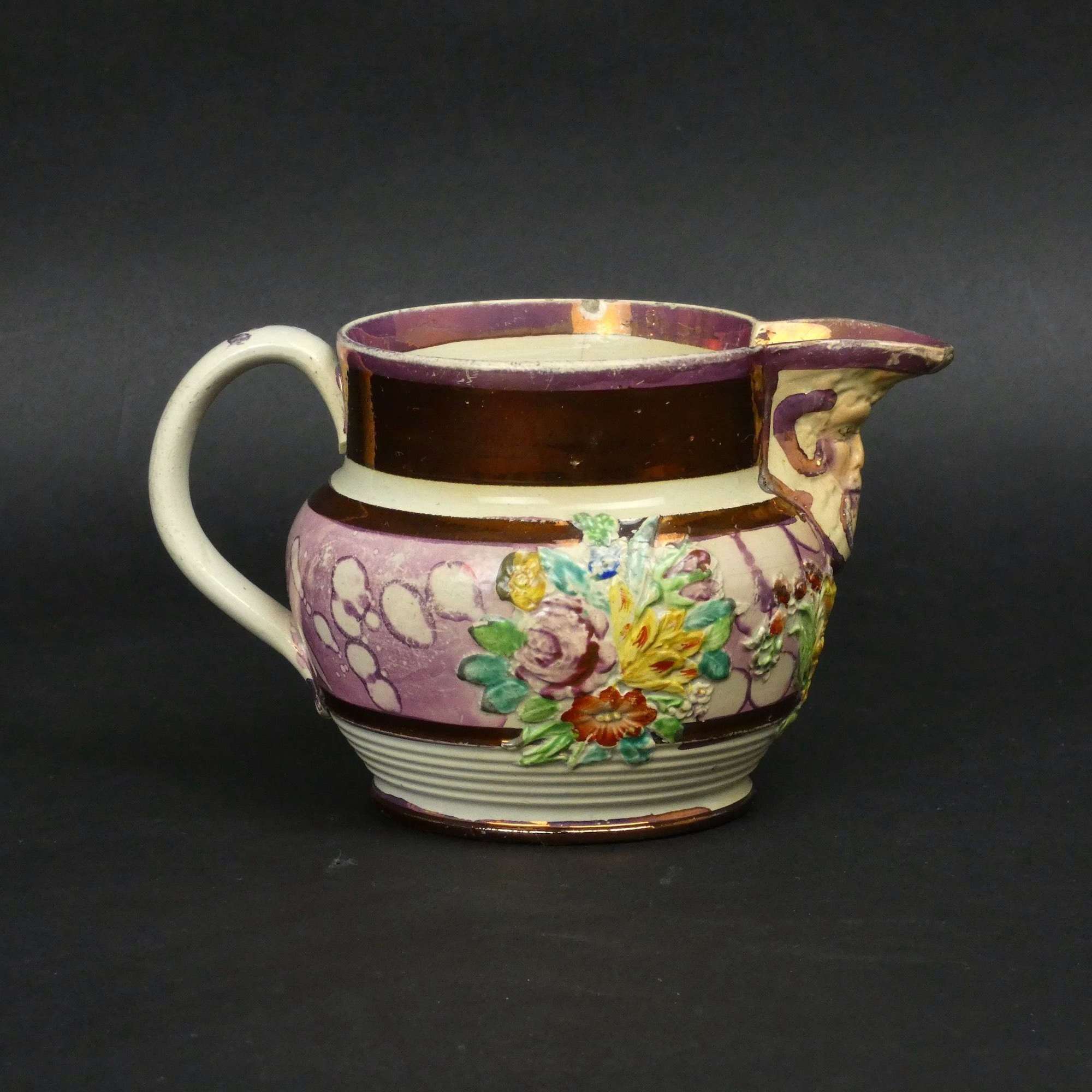 Small, pink lustre jug with moulded decoration
