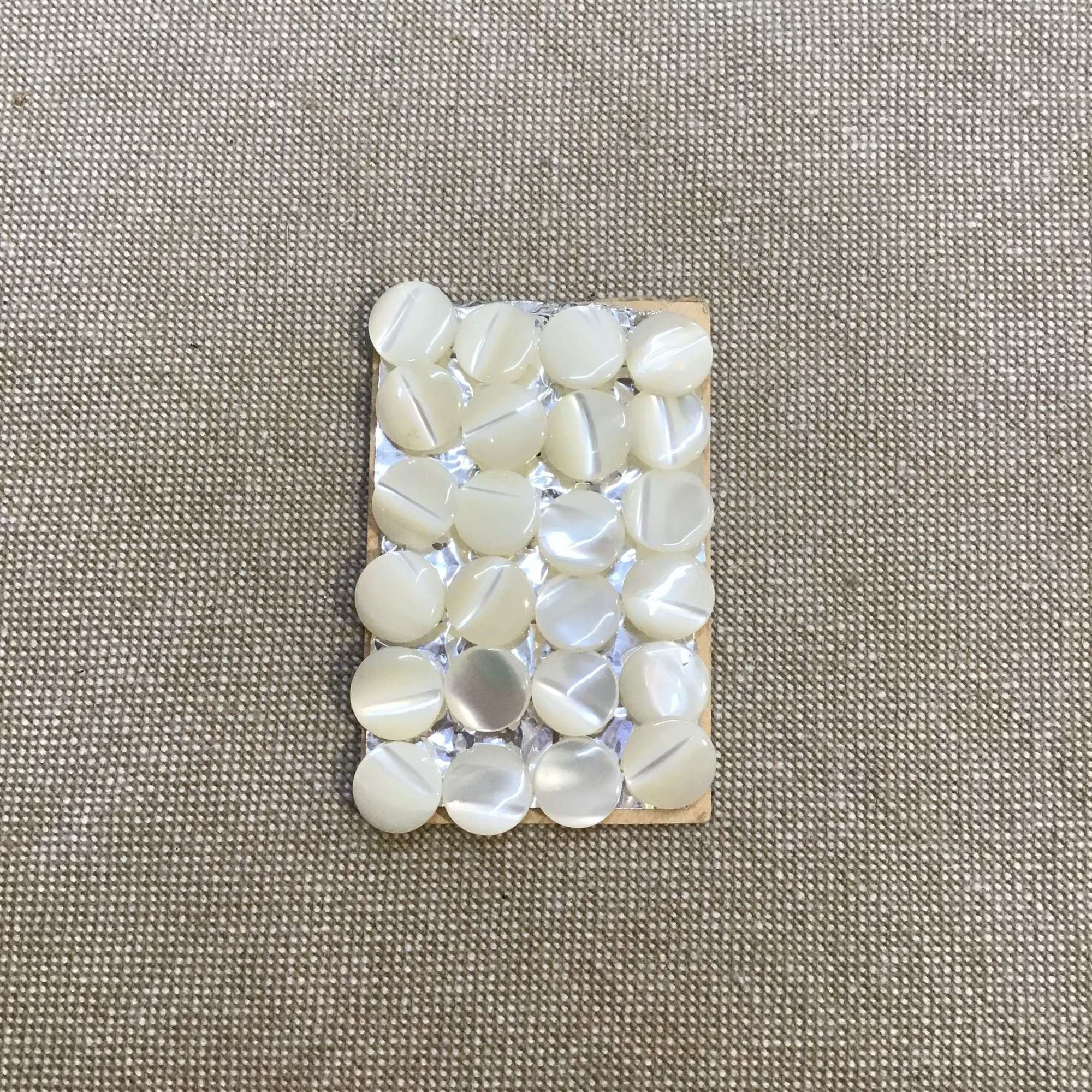 24 small mother of pearl buttons 0.7cm diameter
