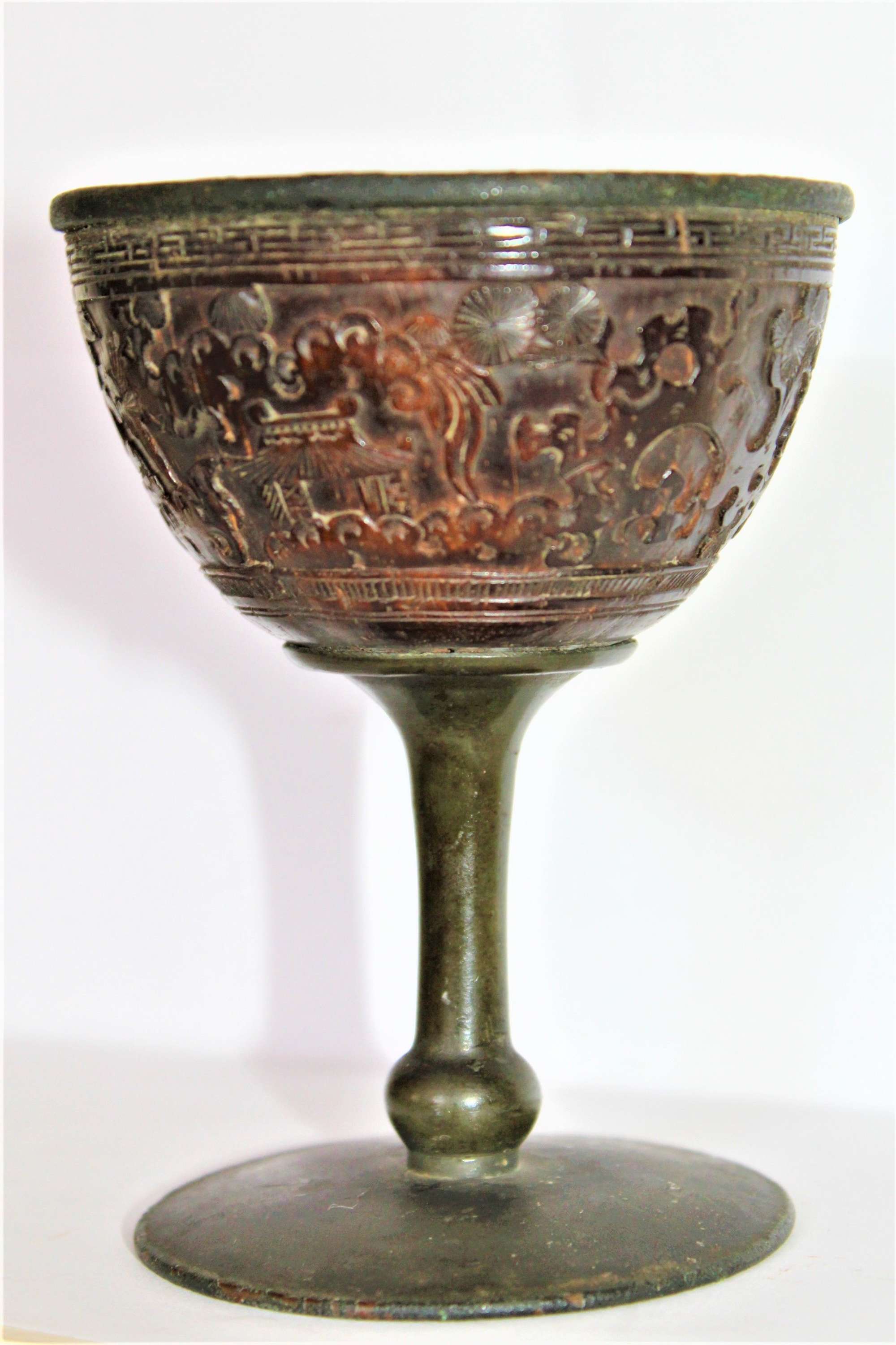 A Chinese Pewter Drinking Cup Wrapped In An Intricately Carved Coconut