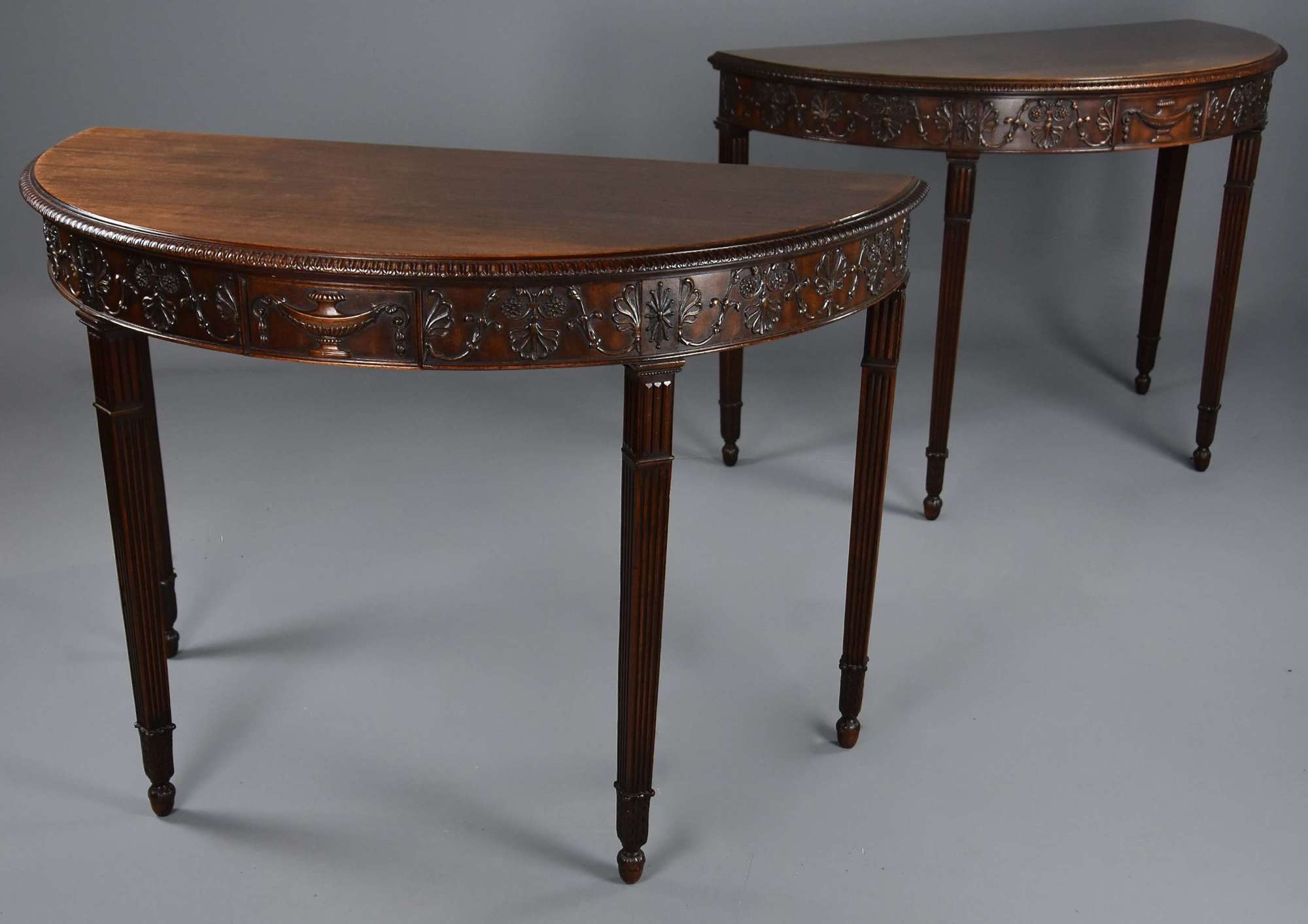 Superb pair of late 19thc mahogany demi-lune console tables